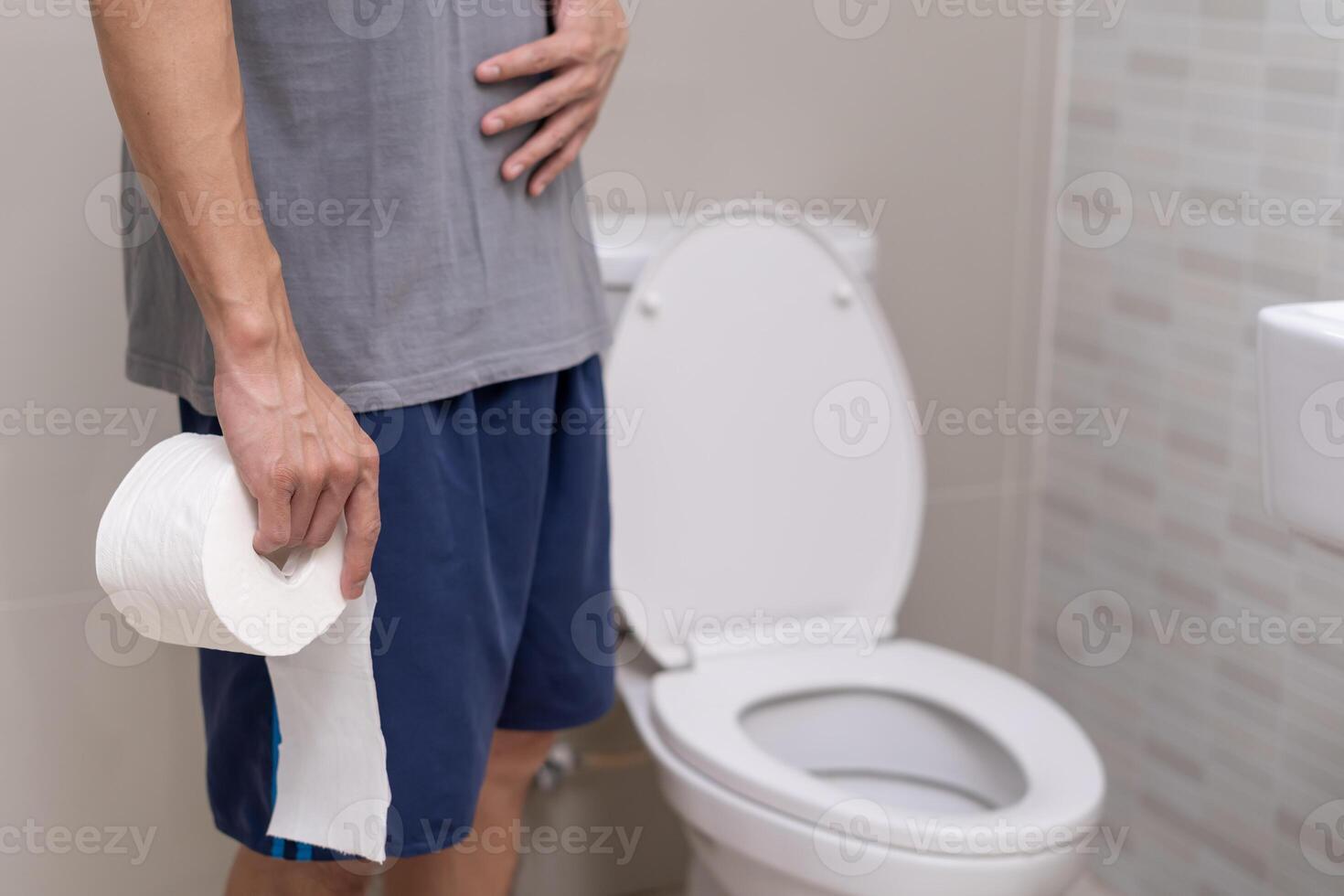 Hurt man touch belly stomach ache painful. colon inflammation problem, toxic food, abdominal pain, abdomen, constipated in toilet, stomachache, Hygiene photo