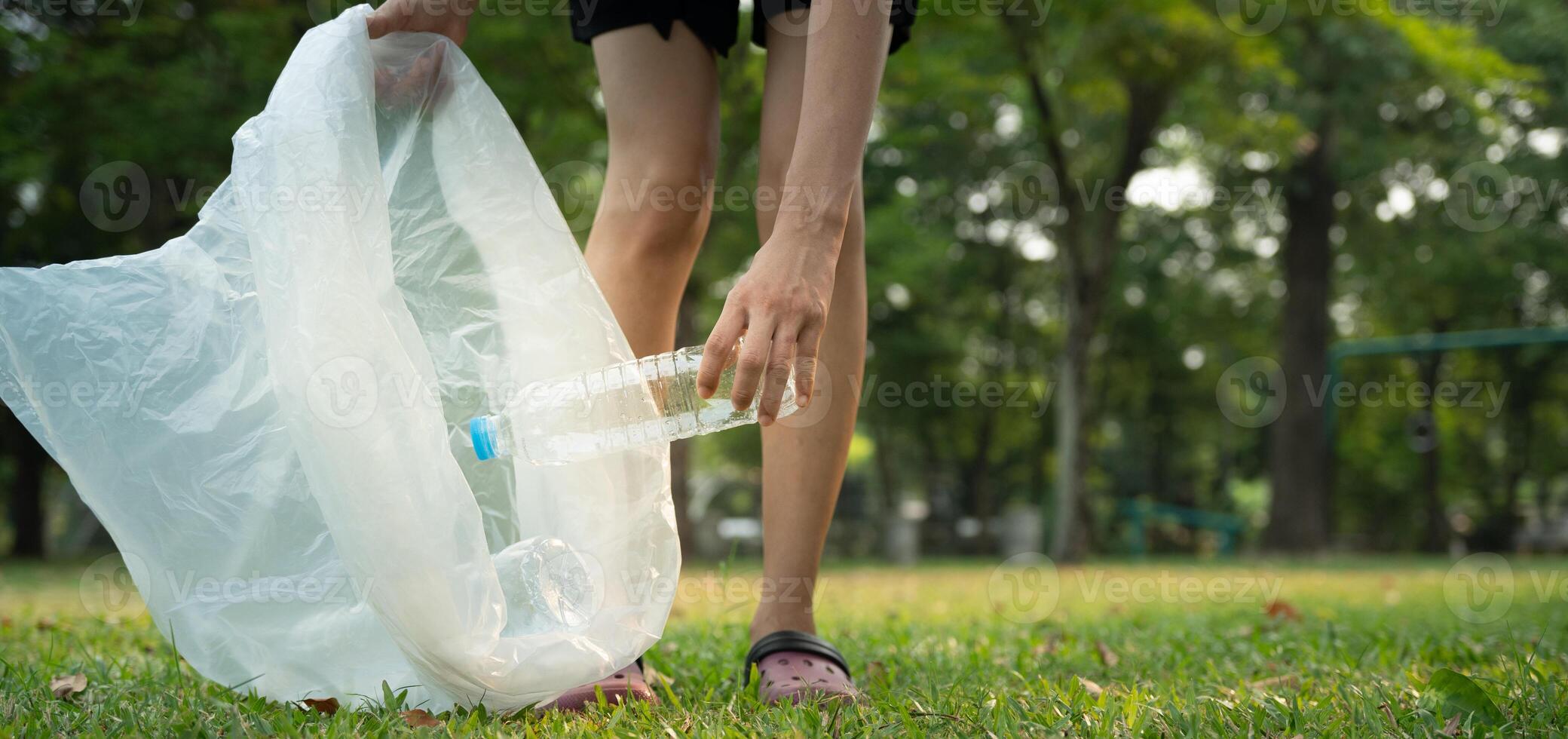 Save earth. Volunteer pick up trash garbage at the park and plastic bottles are difficult decompose prevent harm. Earth, Environment, Greening planet, reduce global warming, Save world photo