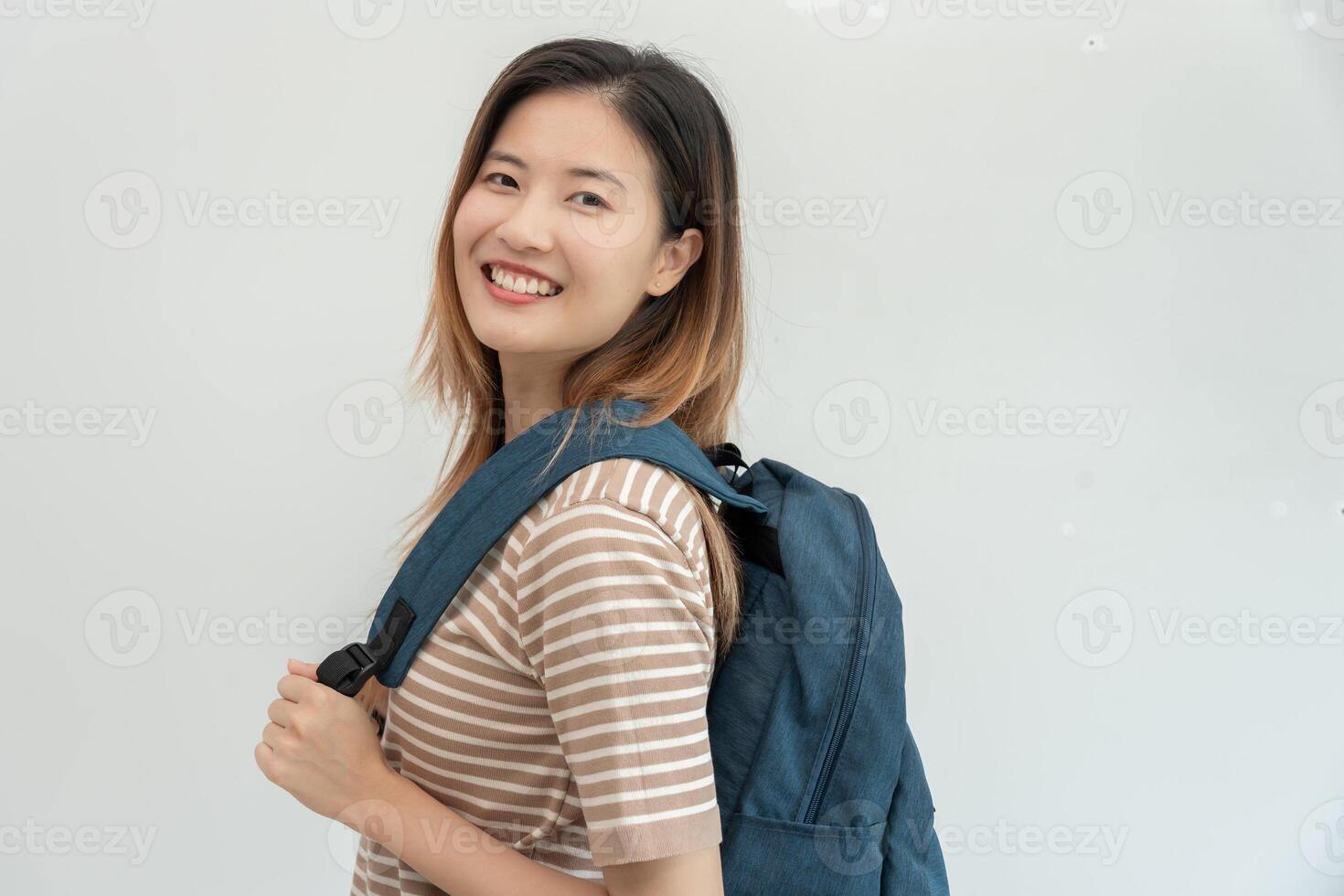 asian woman with backpack and books. Smile girl happy carrying a lot of book in college campus. Portrait female on international Asia University. Education, study, school photo