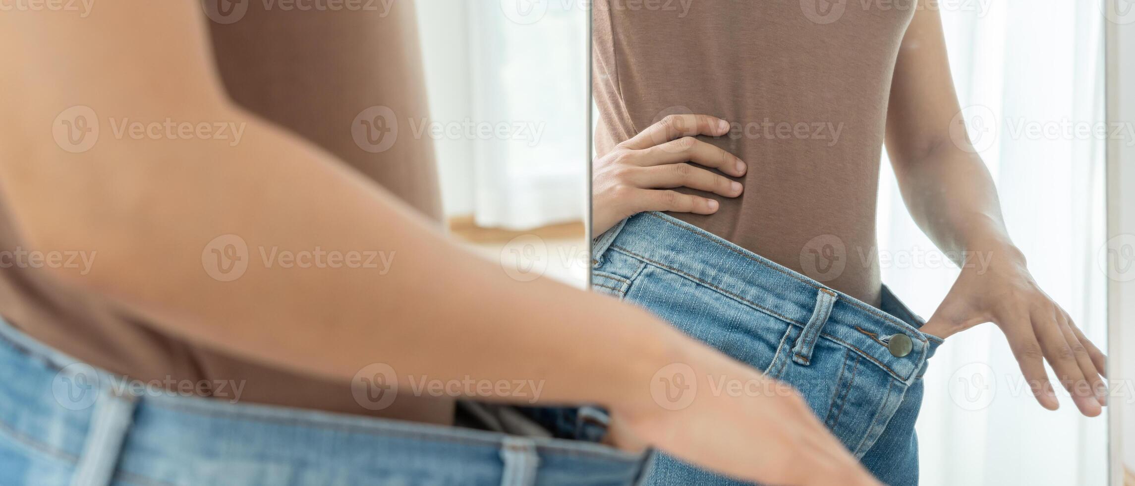 Women showing results of diet. Beautiful shape. female have a reduced waist size after under going a weight loss corse. can not wear jeans due to weight loss. balance, control, routines. photo