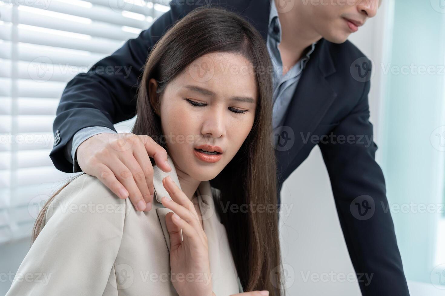 female colleague by touch her shoulder. Sexual harassment in office. Women feel anxious and stressed from being harassed. molest, assault, inappropriate, discrimination photo