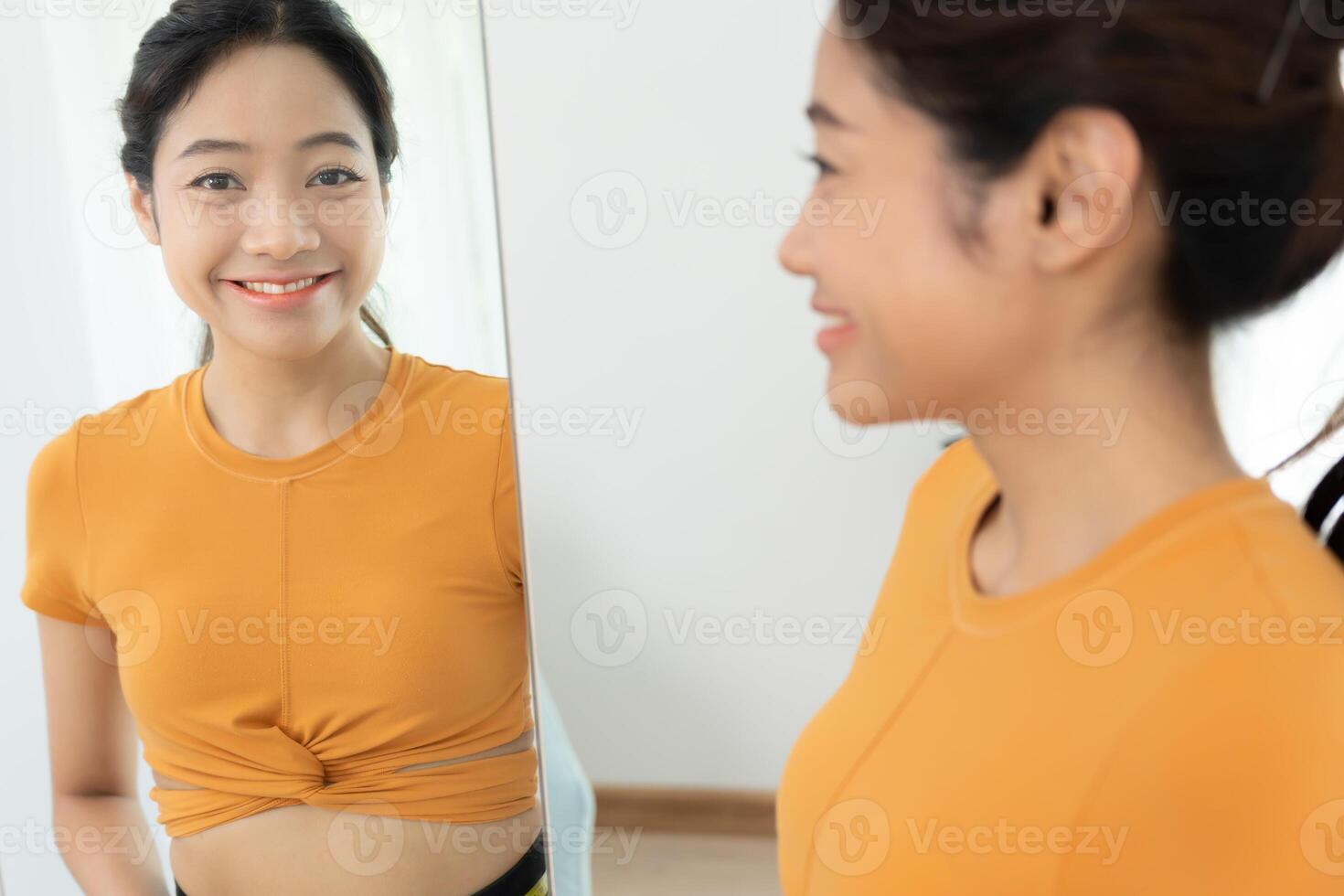 asian women happy results of diet. Beautiful shape. female have a reduced waist size after under going a weight loss corse. can not wear jean due to weight loss. balance, contro photo