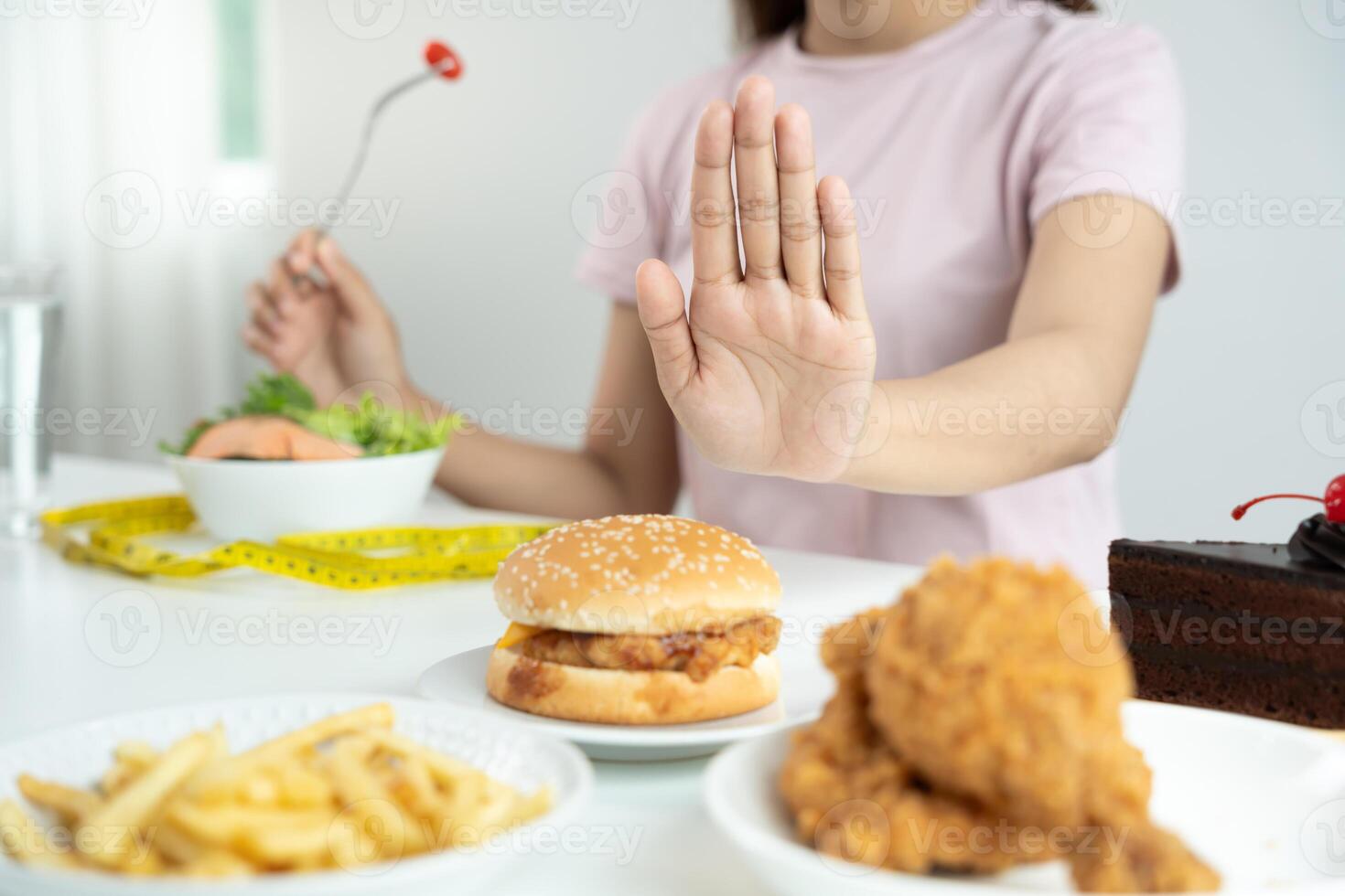 female body confuse hamburger. Woman in restaurant achieves weight loss goal for healthy life, crazy about thinness, thin waist, nutritionist. Diet, body shape photo