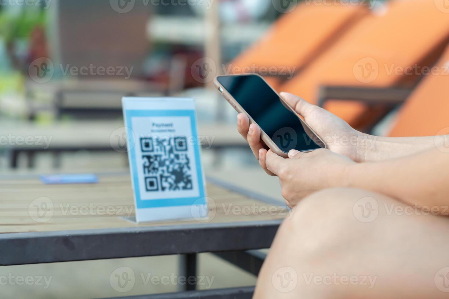 Woman use smartphone to scan QR code for order menu in cafe restaurant with a digital delivery. Choose menu and order accumulate discount. E wallet, technology, pay online, credit. photo