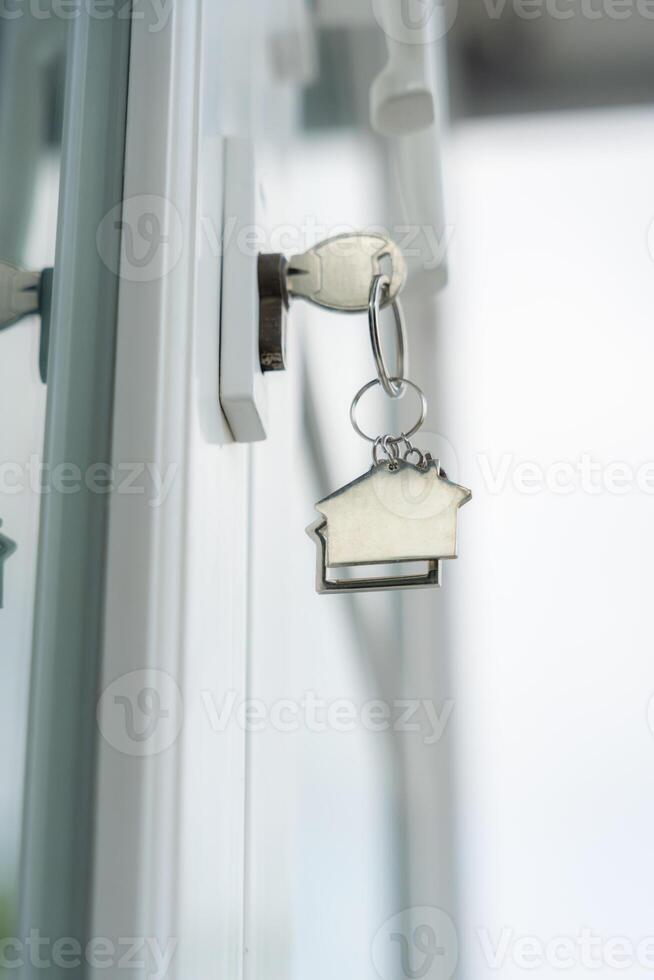 Landlord key for unlocking house is plugged into the door. Second hand house for rent and sale. keychain is photo