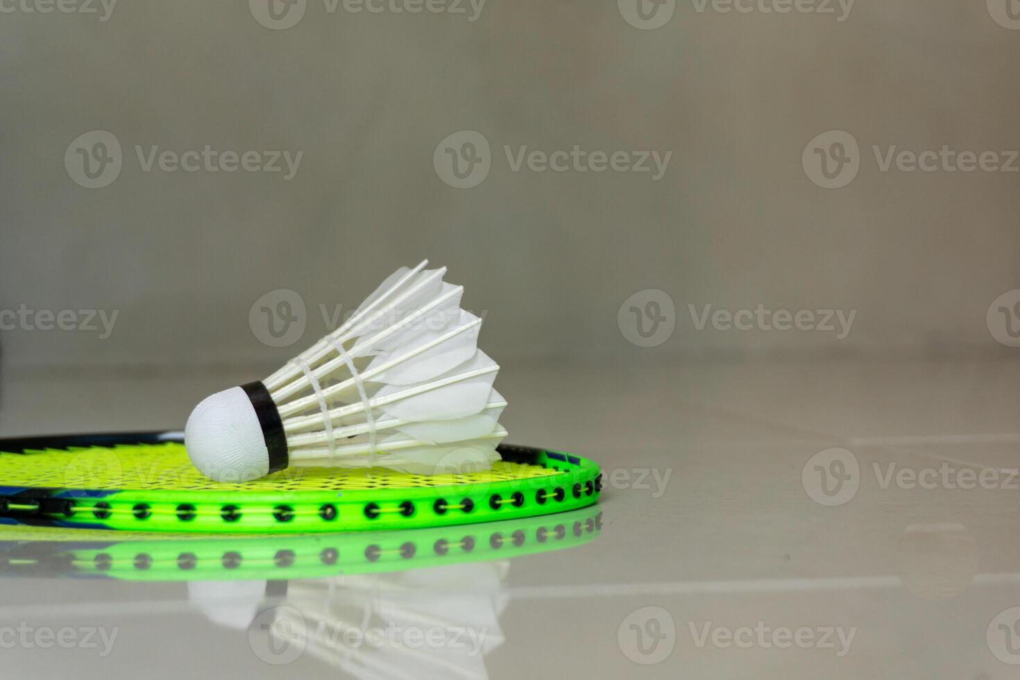 Badminton sport rackets and shuttlecocks on green background. copy space photo