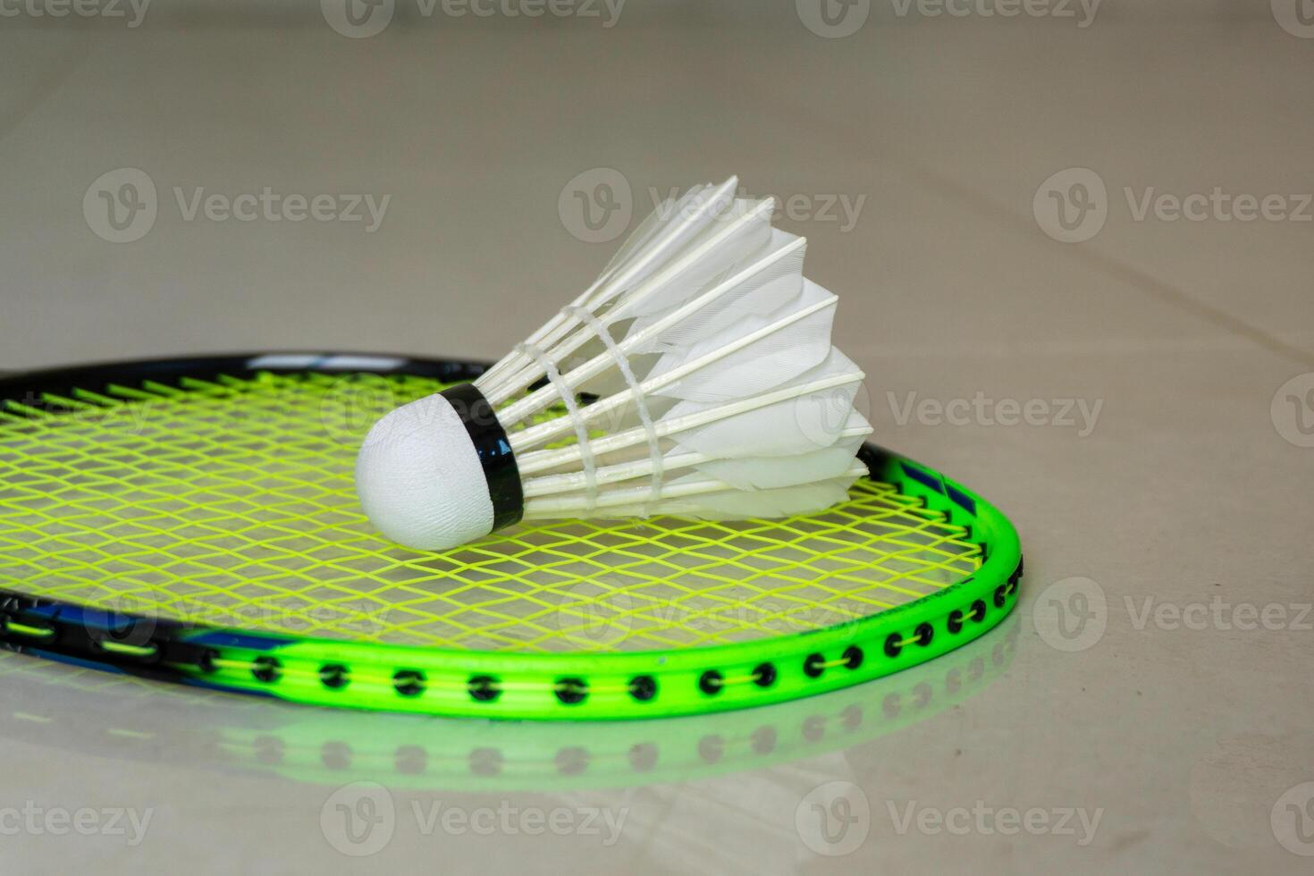 Green Badminton rackets and shuttlecocks on green background. copy space photo
