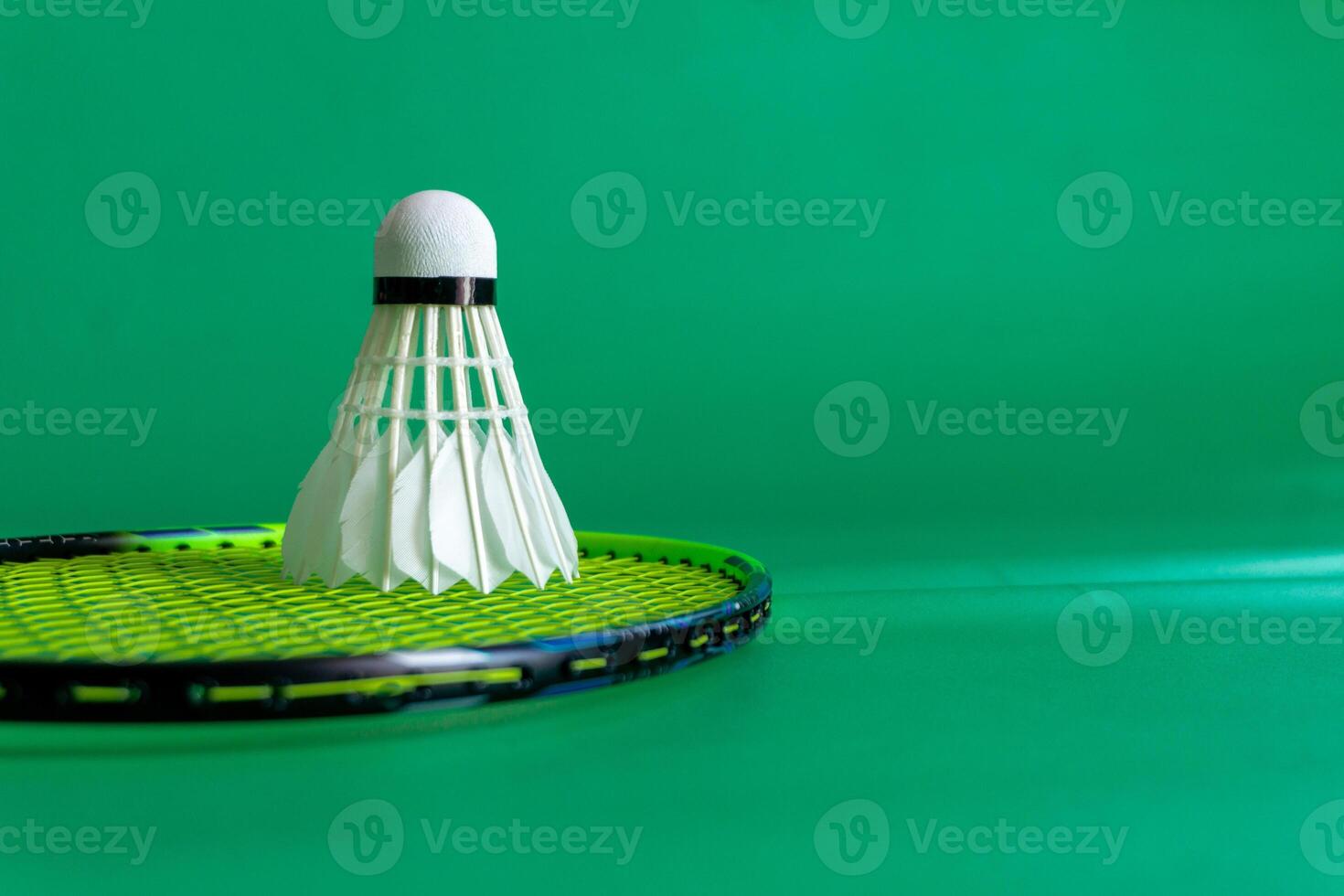 Sports equipment featuring rackets and shuttlecocks arranged on a green surface. photo