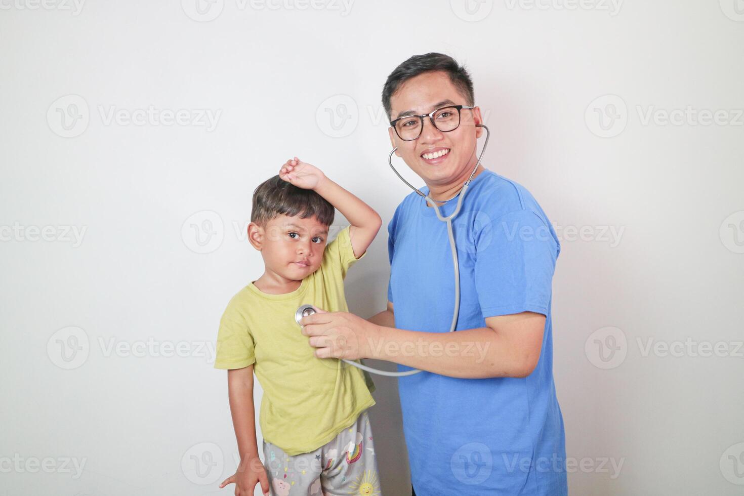 portrait of a kid being checked by a doctor using a stethoscope photo