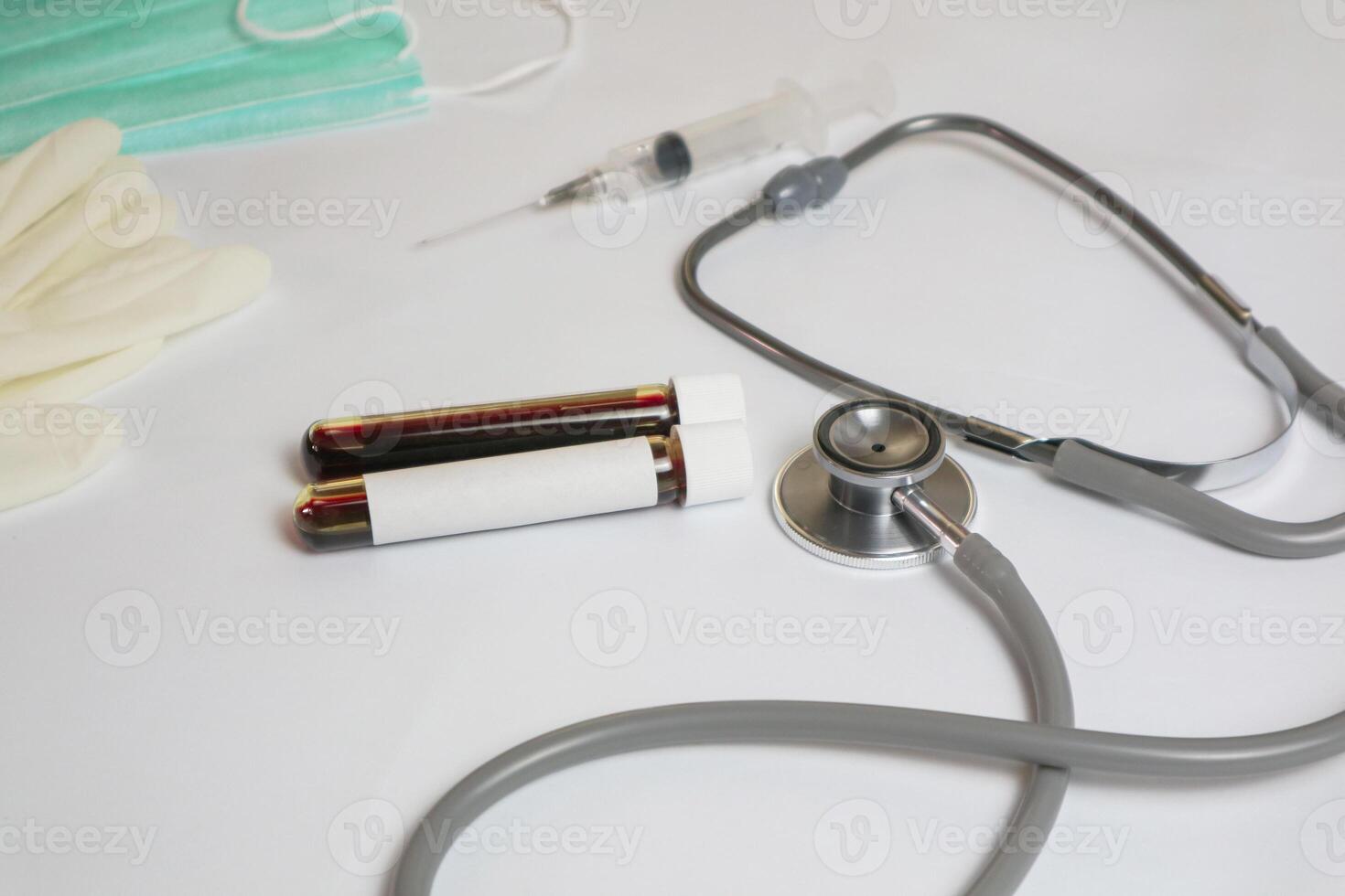 hands of a lab technician with a tube of blood sample and a rack with other samples or lab technician holding blood tube sample for study photo