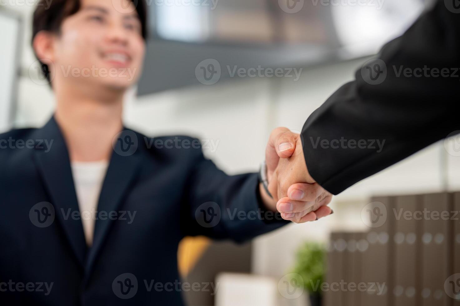 A close-up of a businessman shaking hands with his colleague or business partner. photo