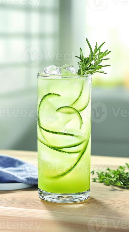 Vibrant mocktail served in a clear tall glass with cucumber slices and herbs at a bright indoor setting photo