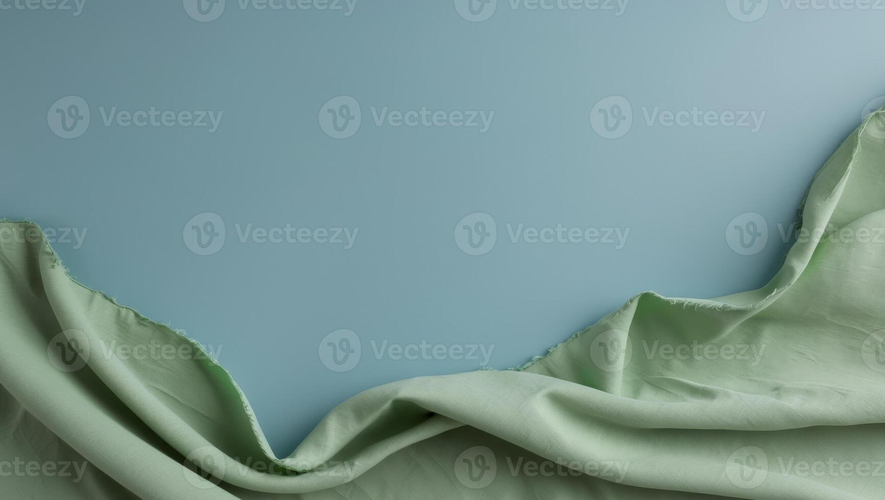 A blue background with a green fabric draped over it photo