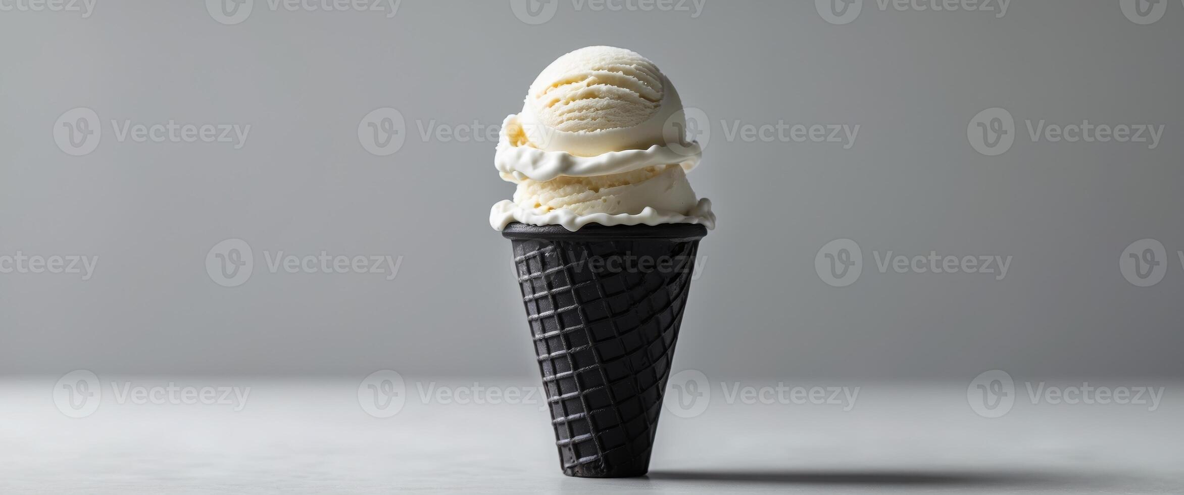 Black waffle cone with vanilla ice cream and dramatic lighting photo
