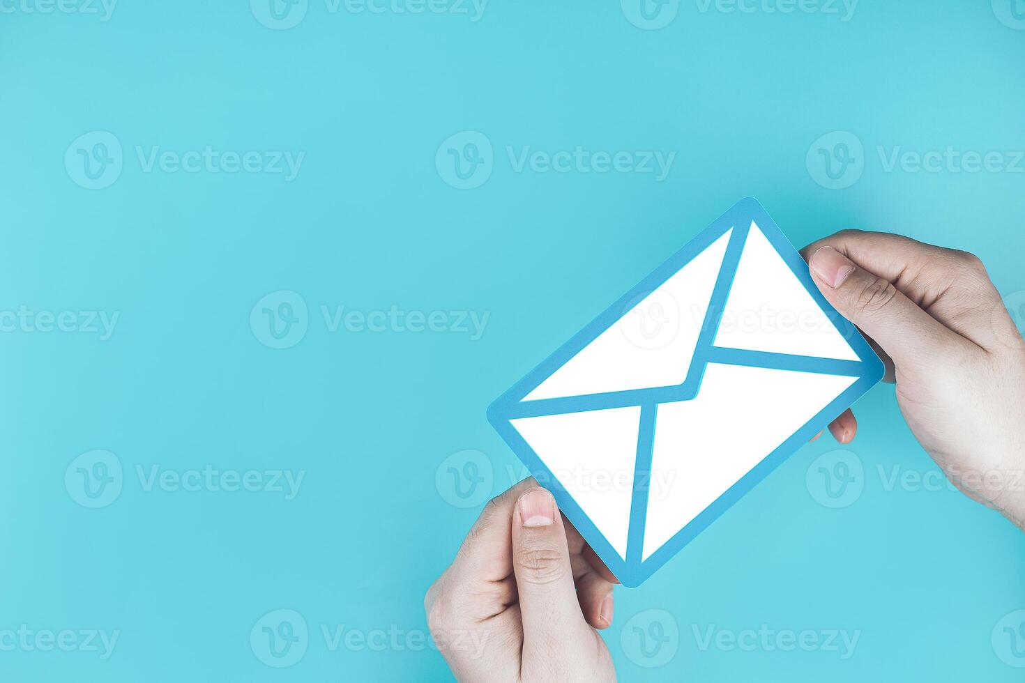 Paper letter on blue background, with copy space. Business concepts of online contact channels, electronic mail inbox notifications, and sending and receiving documents using online networks. photo