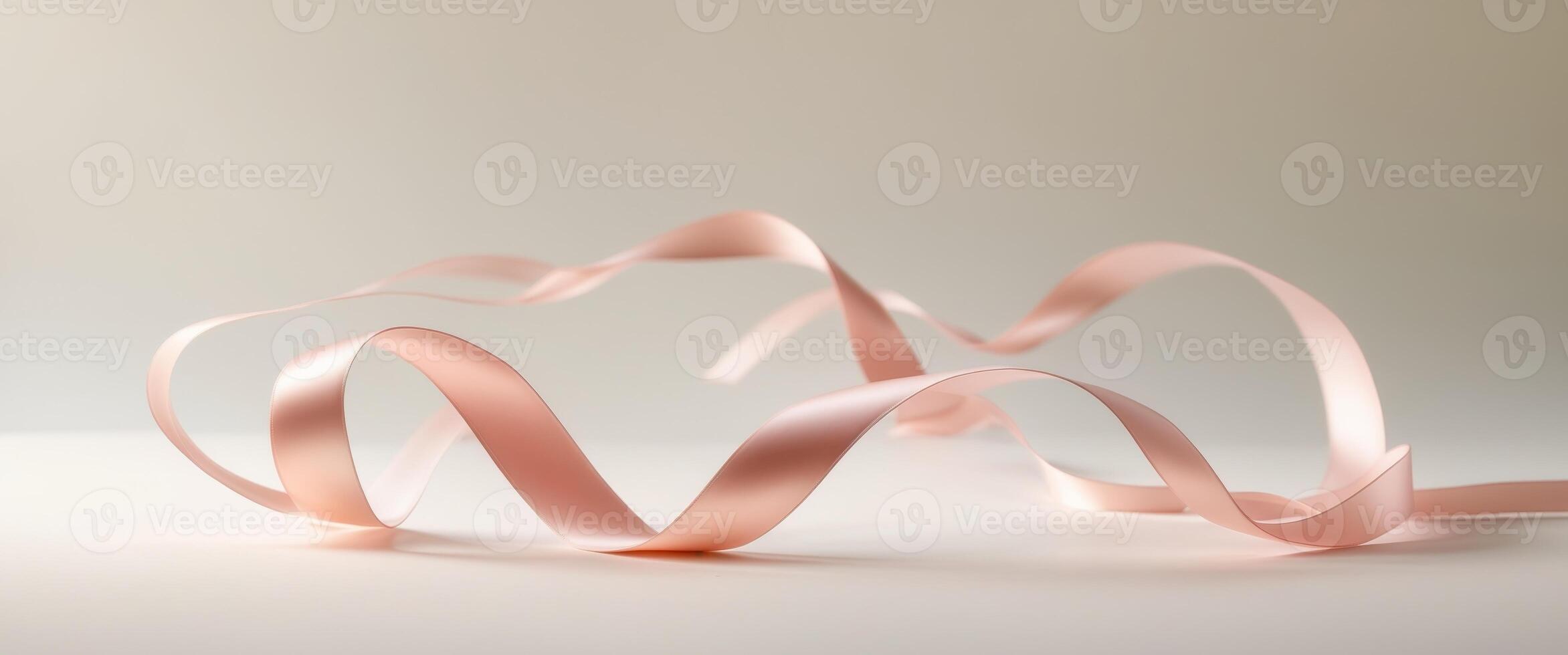 Pink ribbon dances gracefully on a soft background to evoke elegance and charm photo