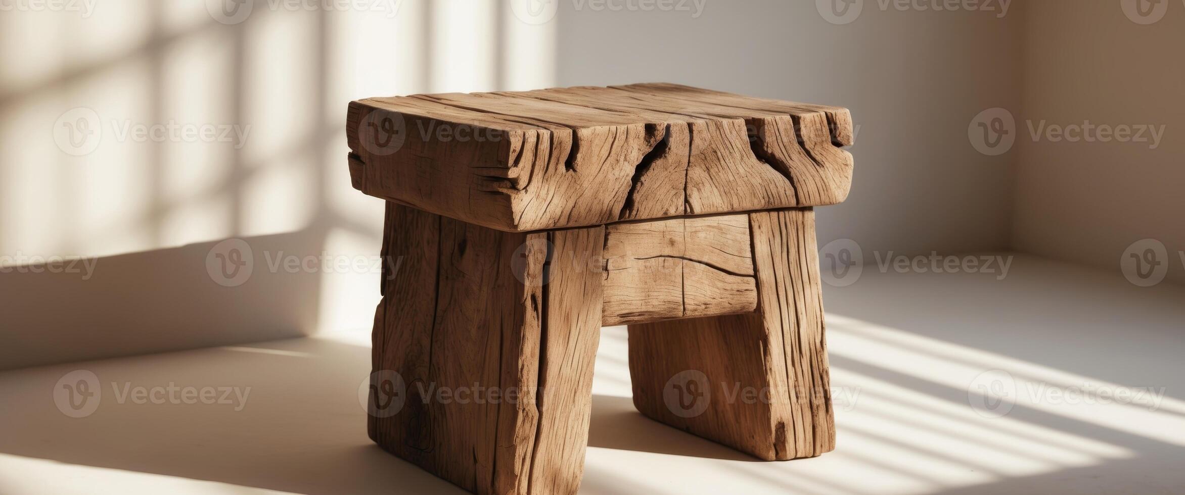 Rustic wooden stool in natural light with textured shadows indoors photo