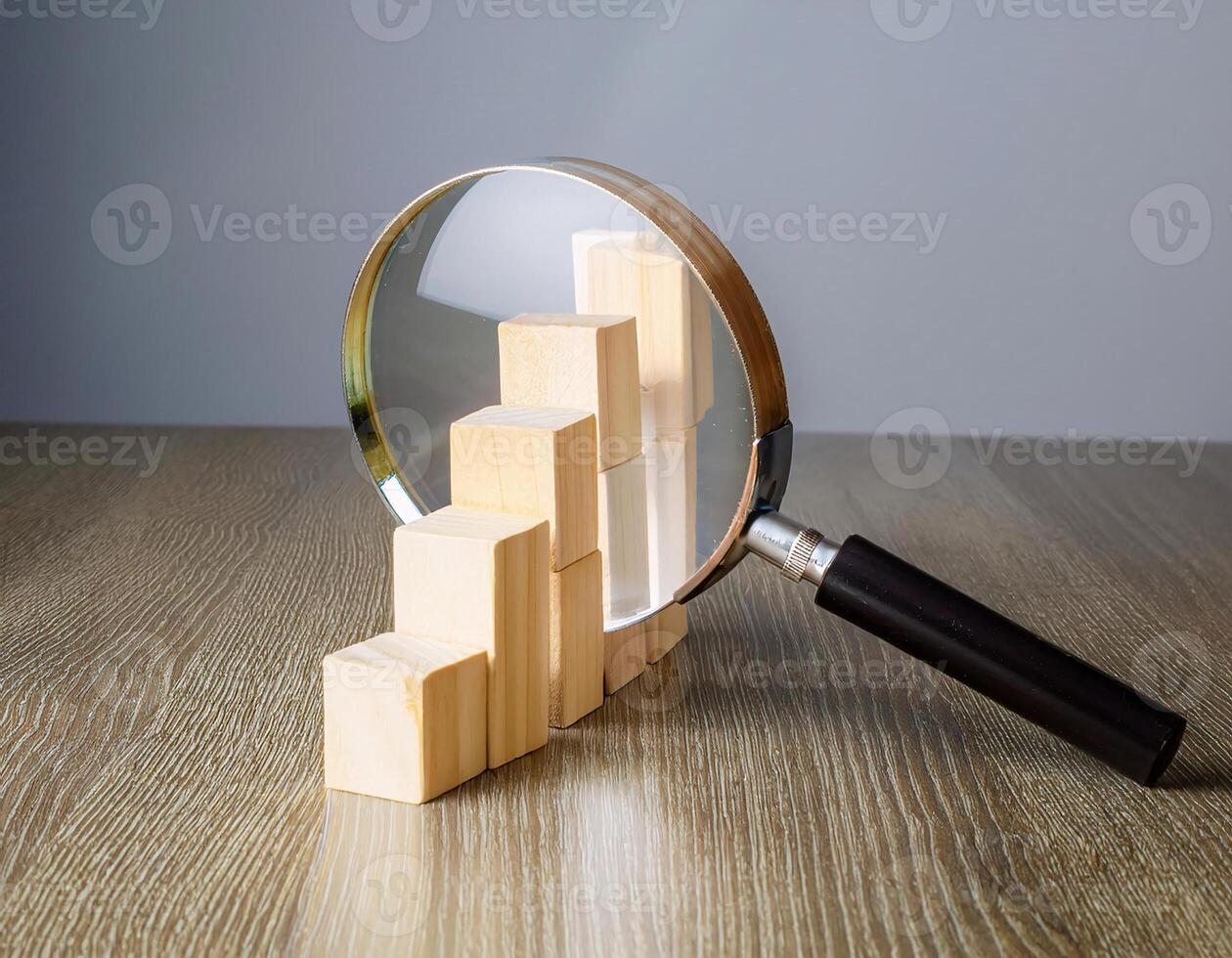 Data Investigation Wooden Blocks and Magnifying Glass in Focus photo