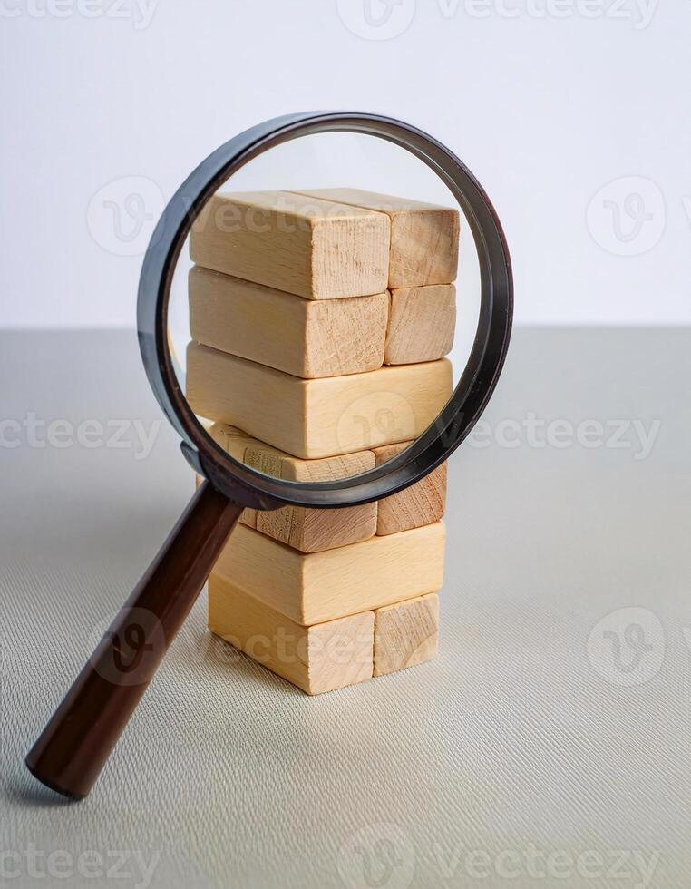 Side View of Magnifying Glass and Wooden Blocks for Data Analysis photo