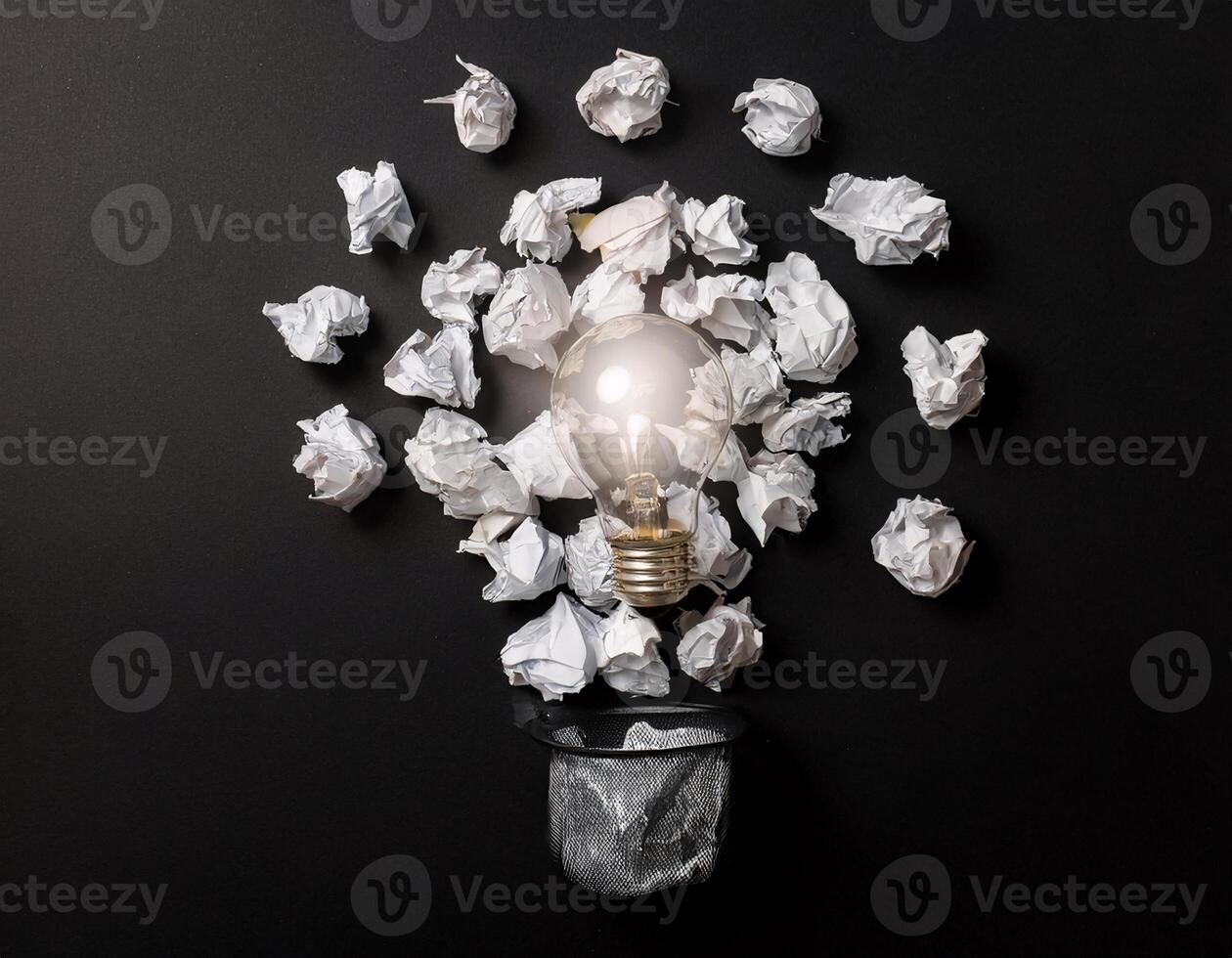 Top View of Lamp and Crushed Paper Representing Creative Ideas on Black photo