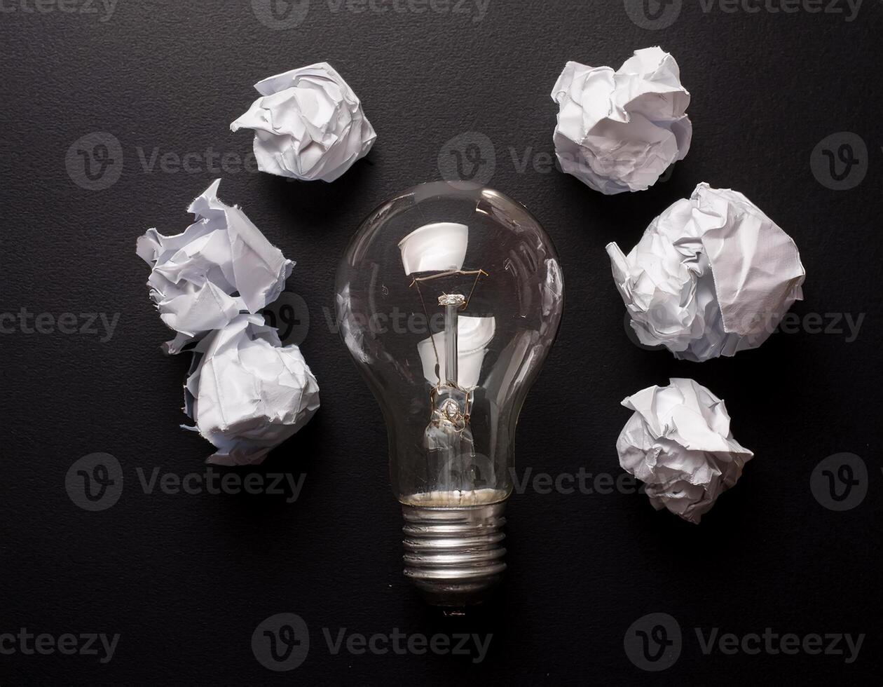 Lightbulb and Crumpled Paper Symbolizing Inspiration, Shot from Above photo