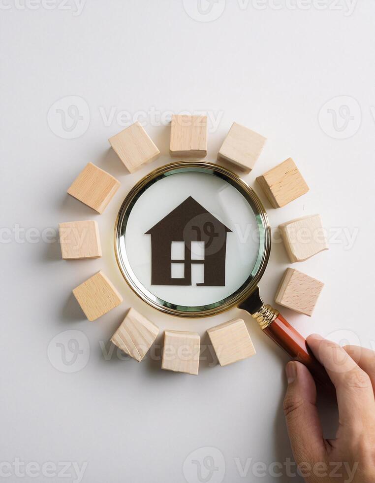 Magnifying Glass Over Wooden Blocks and Paper Home Icon, Real Estate Concept photo