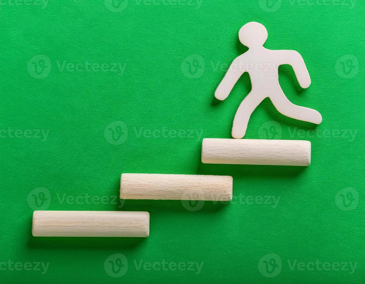 Concept of Success Wooden Figures Ascend a Challenging Slope photo