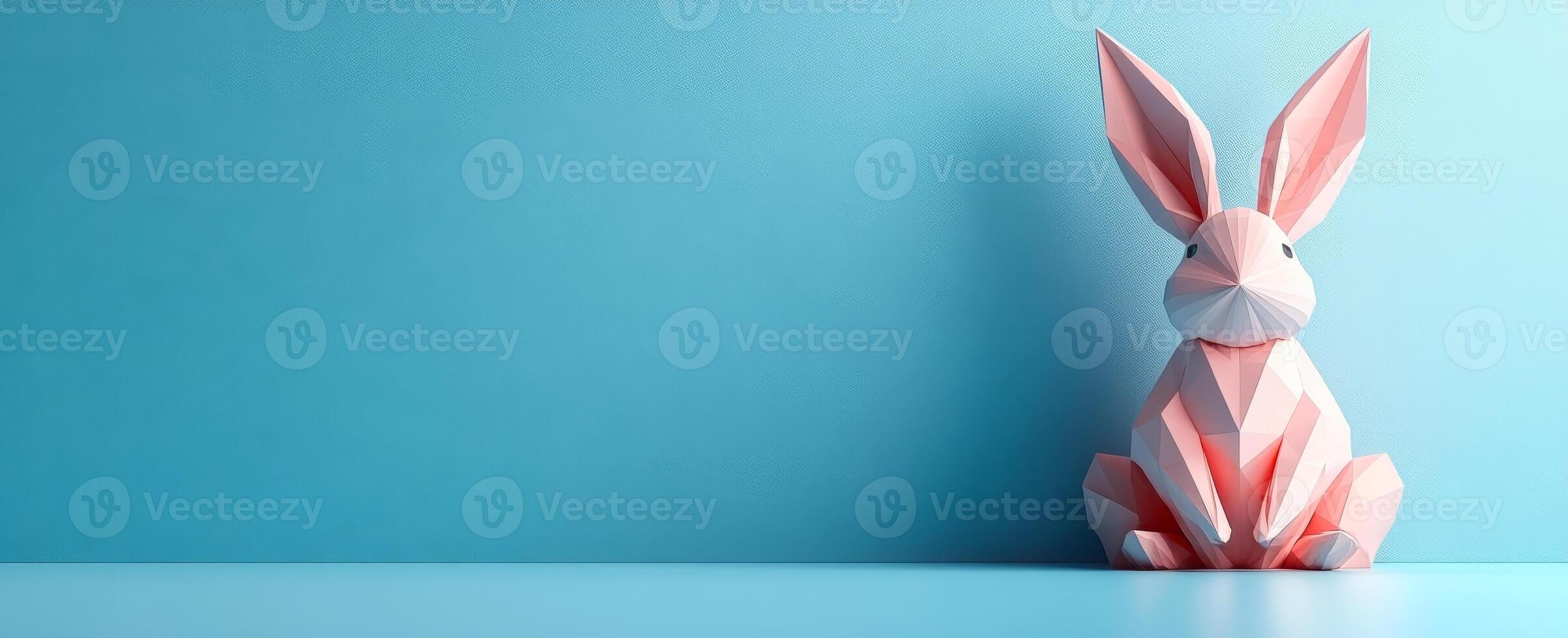 Bright rabbit on blue. A vibrant pink and white paper bunny sits against a solid blue backdrop, showcasing its detailed origami design. photo