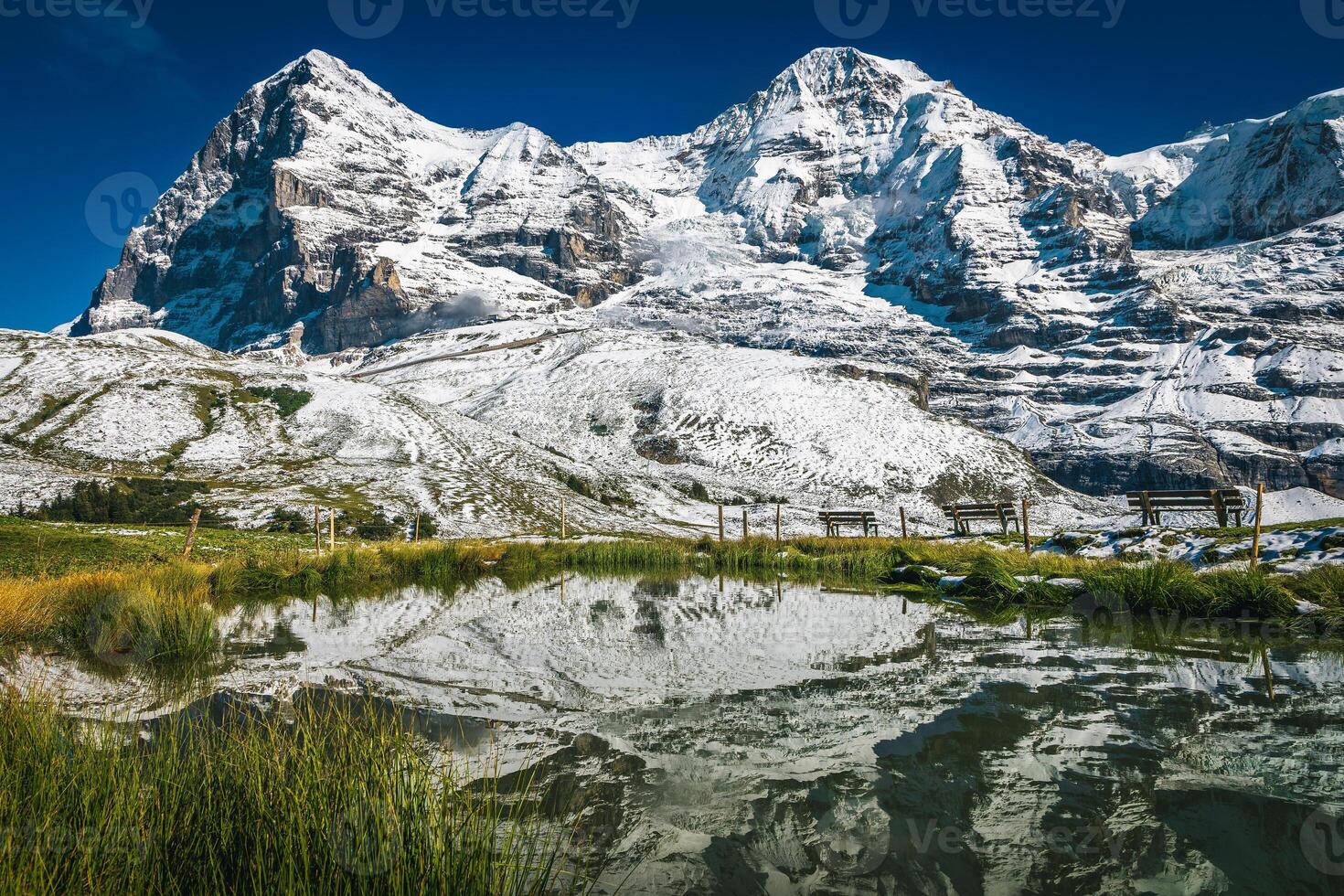 Small lake and high snowy mountains in background, Grindelwald, Switzerland photo
