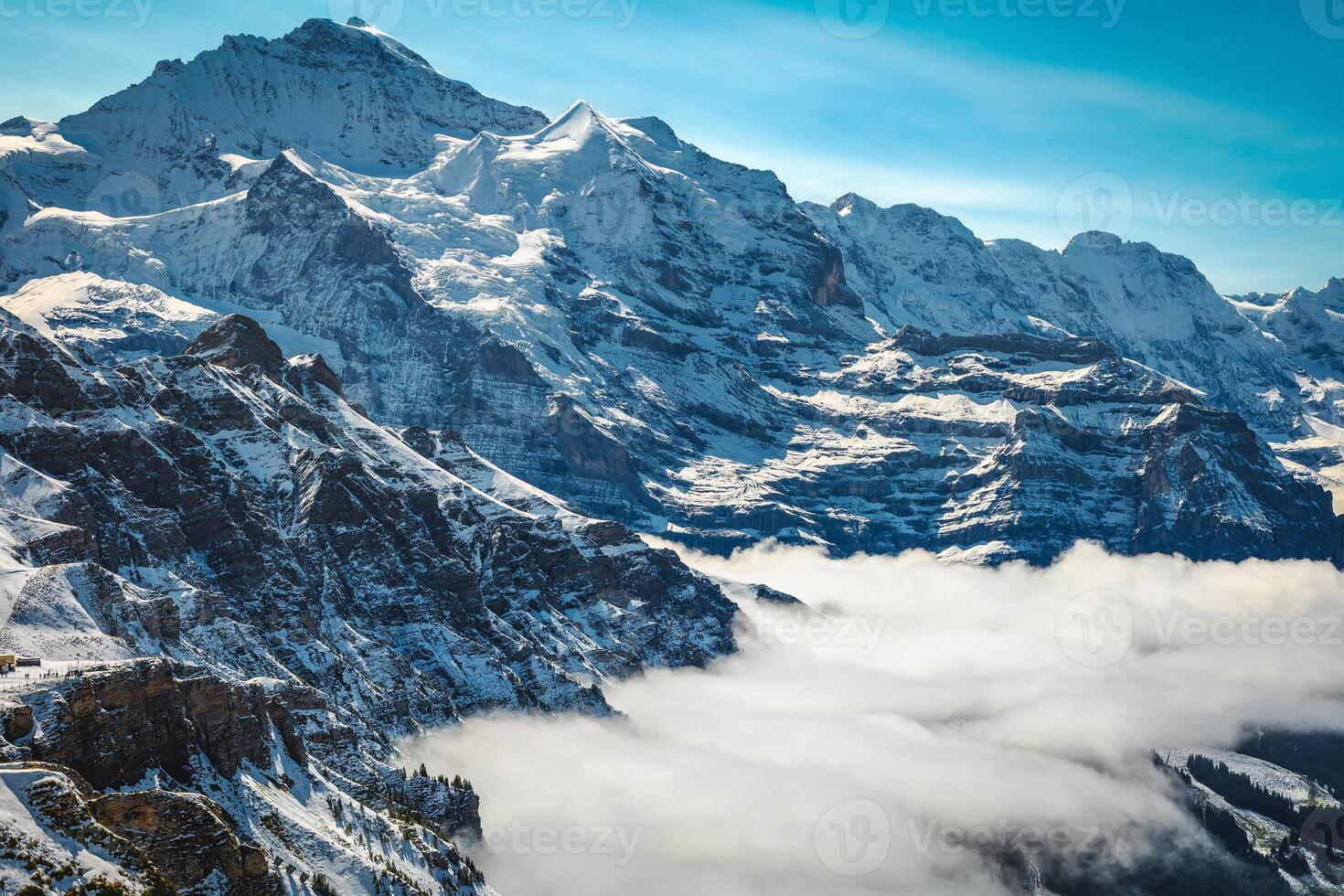Jungfrau peak above the misty valley, Lauterbrunnen, Switzerland photo