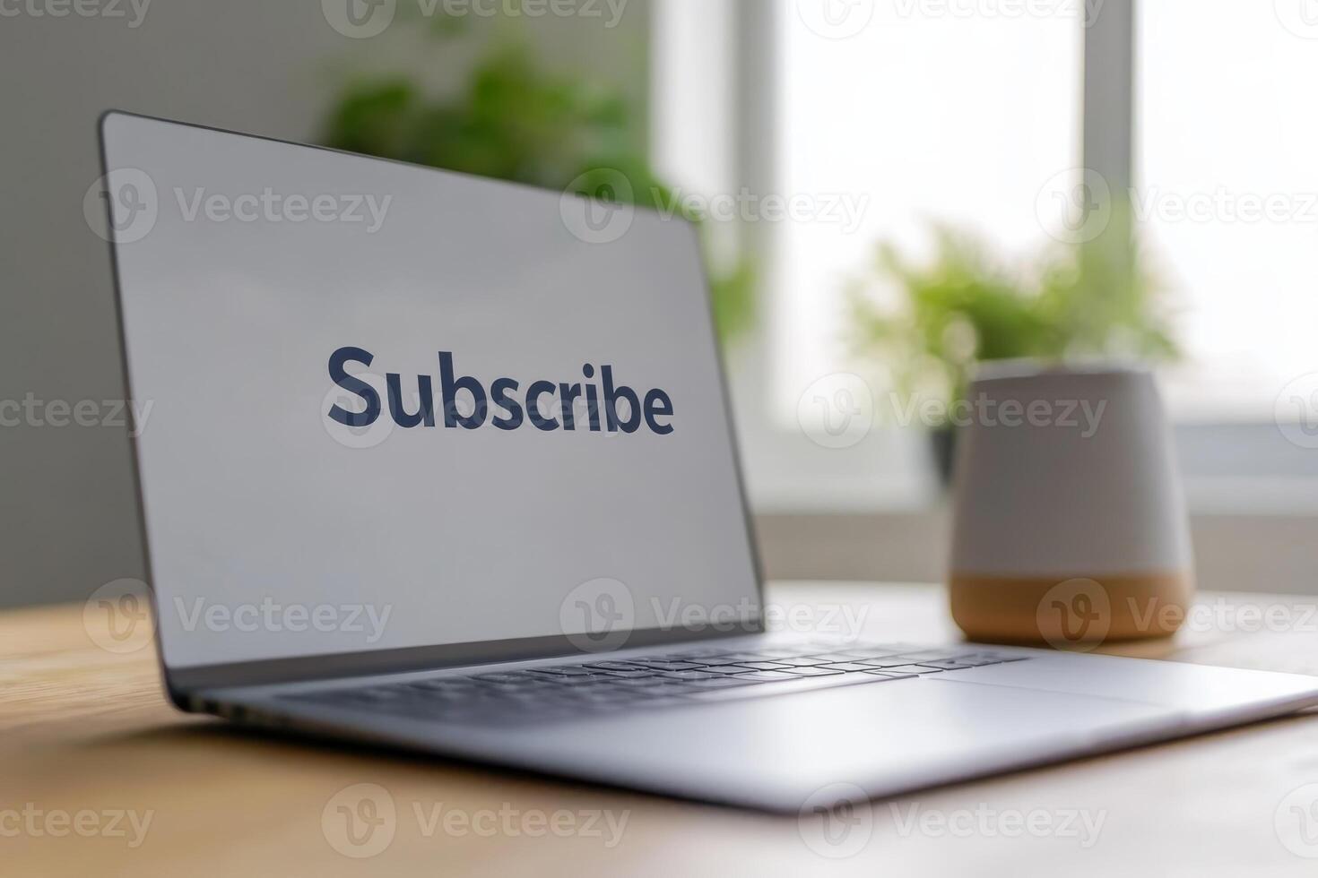 Engaging desk setup featuring a laptop screen displaying a subscribe prompt in a bright, inviting workspace photo