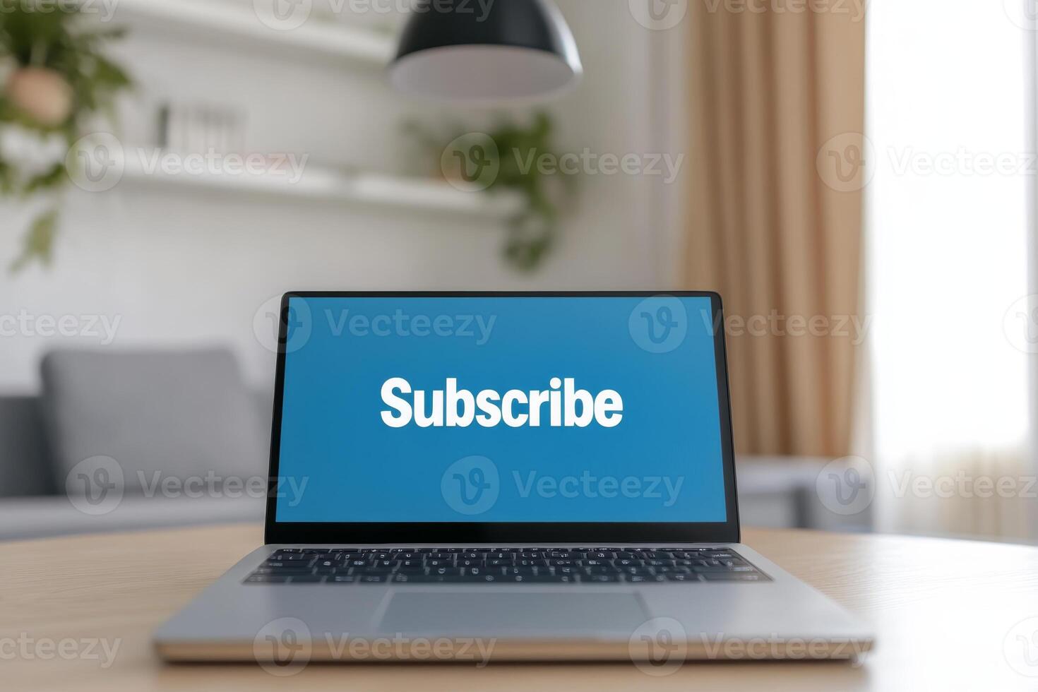Laptop displaying subscribe message in a cozy indoor setting with soft lighting and minimalistic decor photo