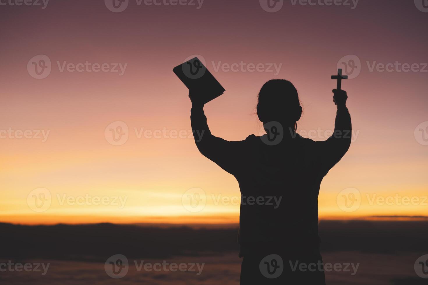 silhouette of a man Praying hands with faith in religion and belief in God On the morning sunrise background. Prayer position. photo