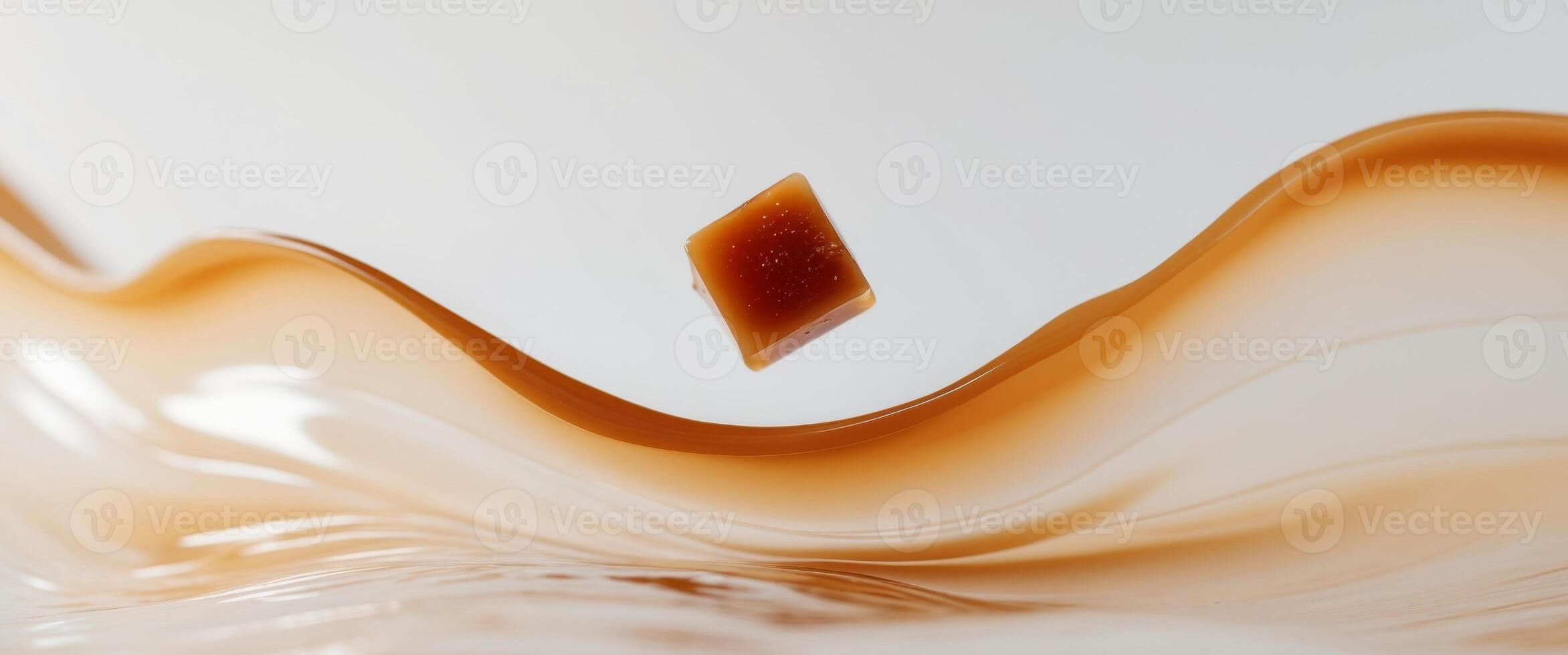 Delicious Caramel Cube Splashing in Liquid Caramel. photo