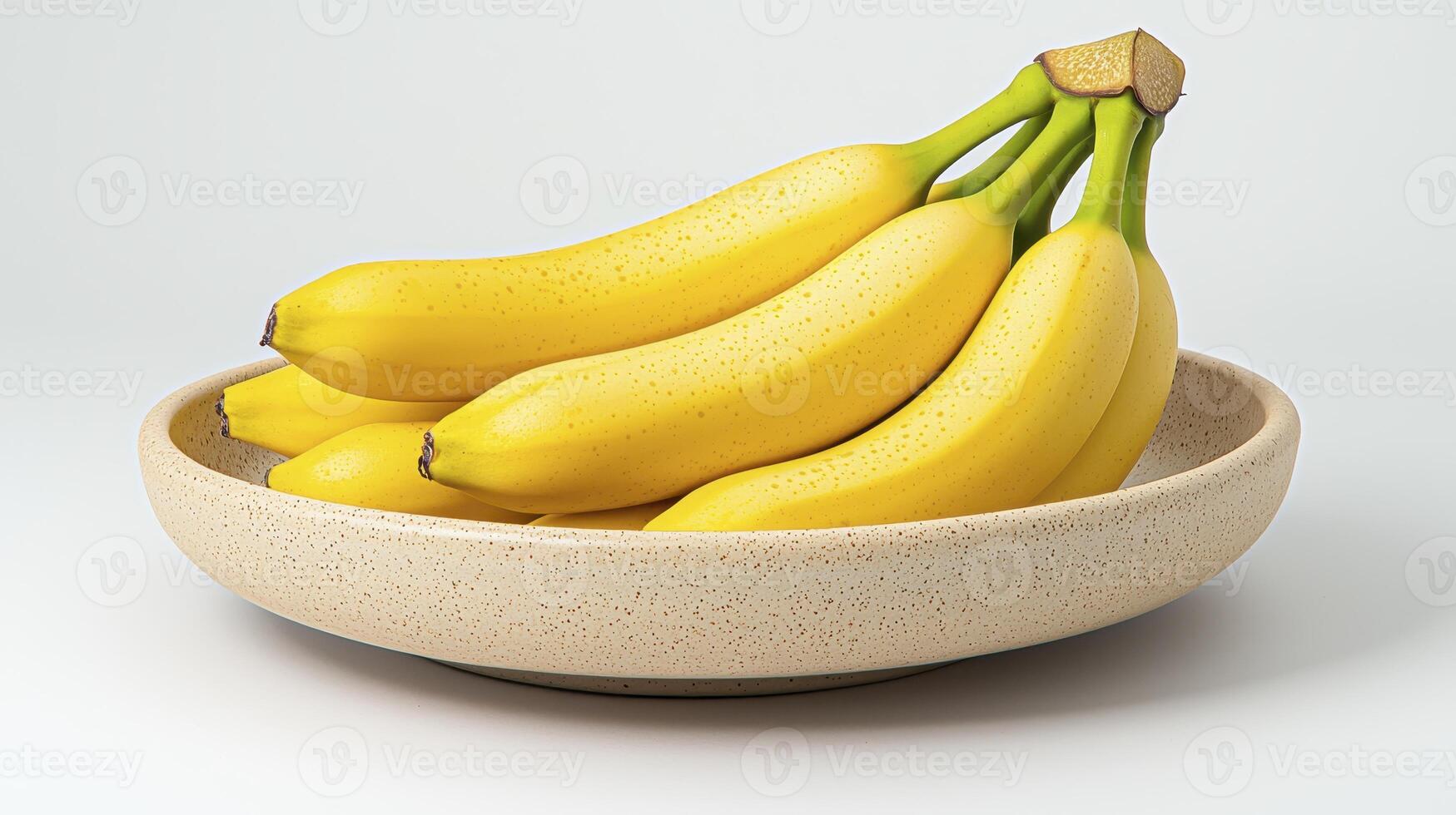 Vibrant yellow bananas elegantly displayed in a textured speckled bowl on a clean white background photo
