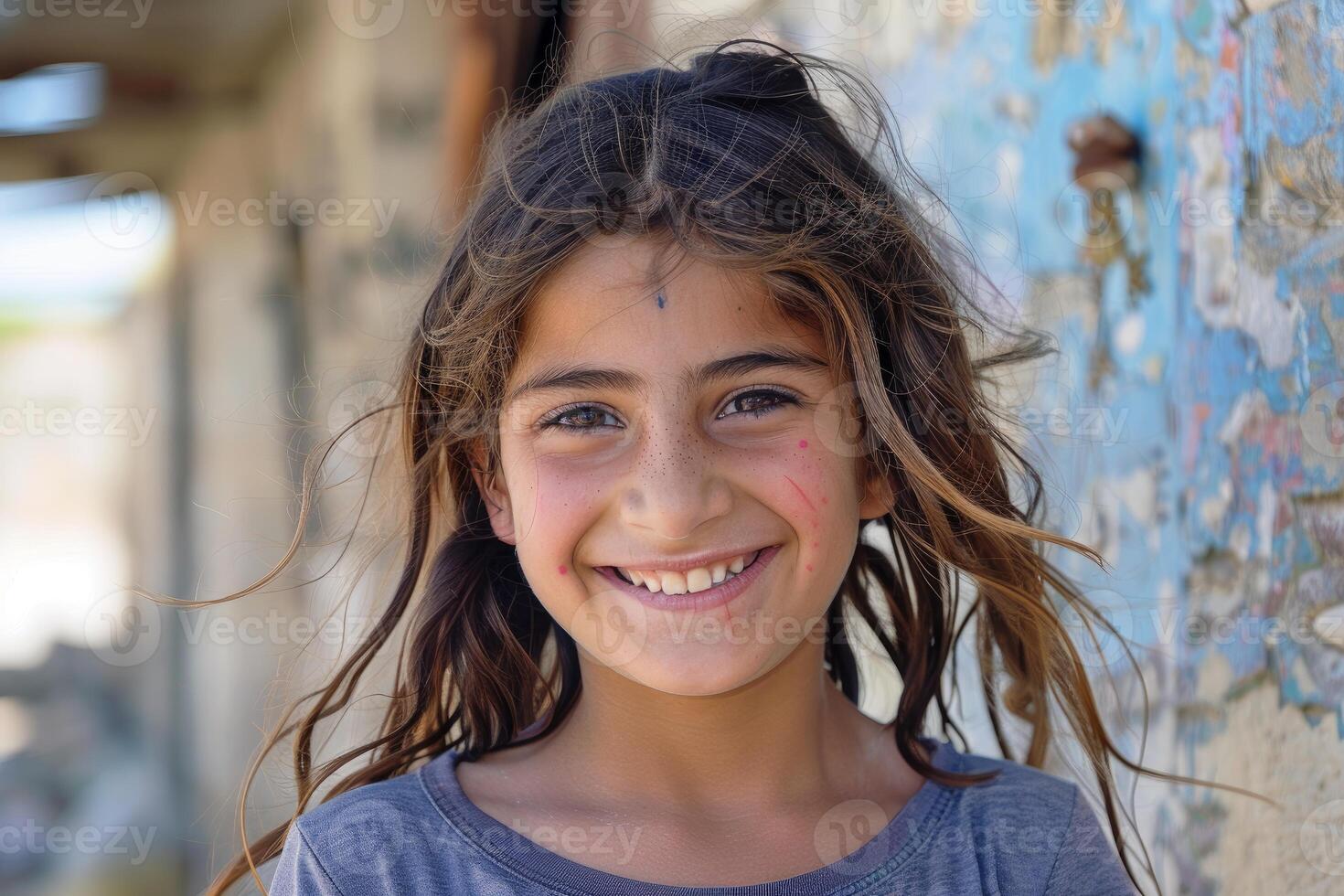 Portrait of smiling refugee girl in war torn city photo