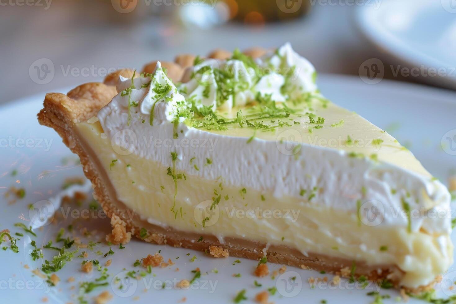 Key lime pie showing filling and topped with whipped cream and lime zest photo