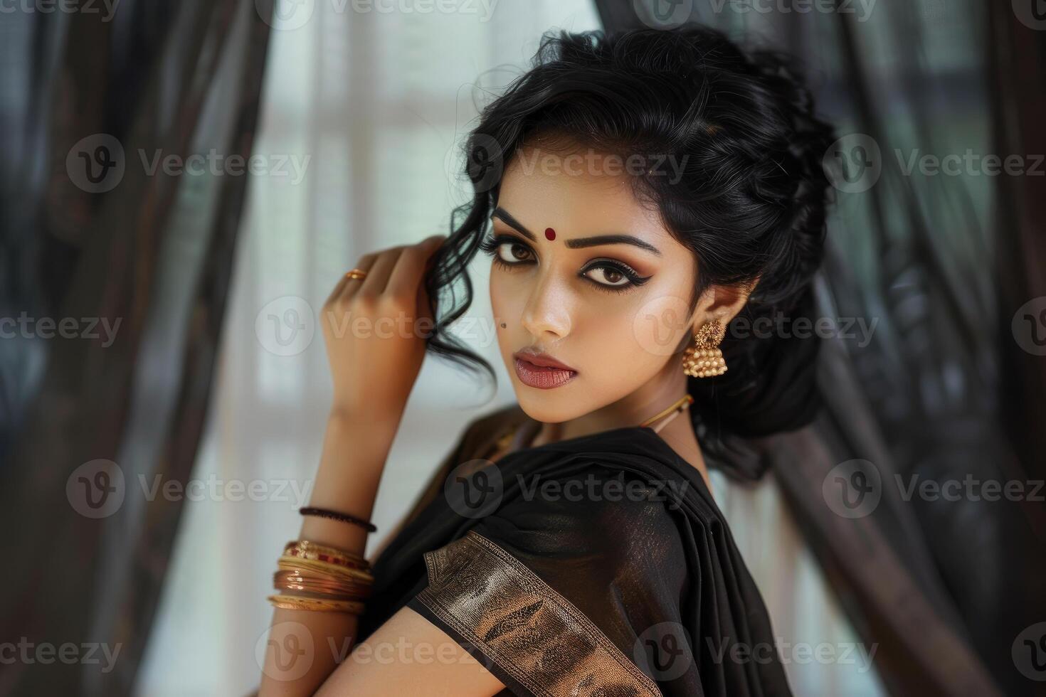 Beautiful indian woman wearing traditional sari and jewelry posing indoors photo
