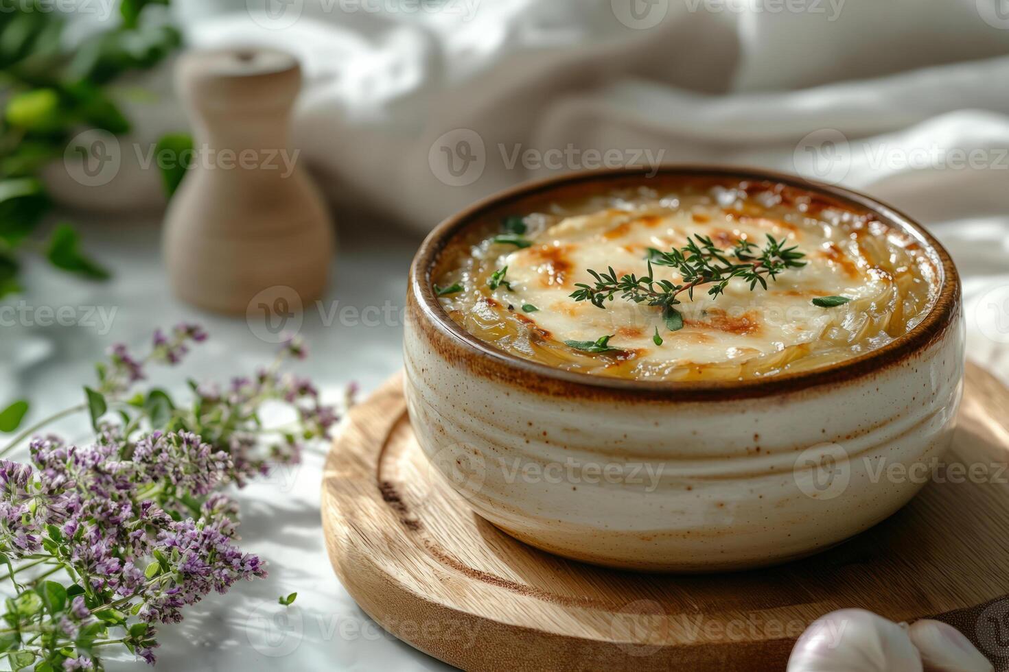 French onion soup topped with melted cheese and thyme photo