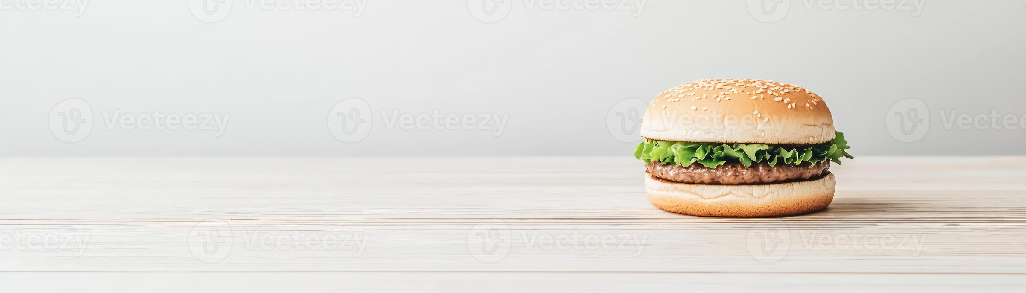 Delicious hamburger with fresh vegetables on a minimalist wooden table. photo