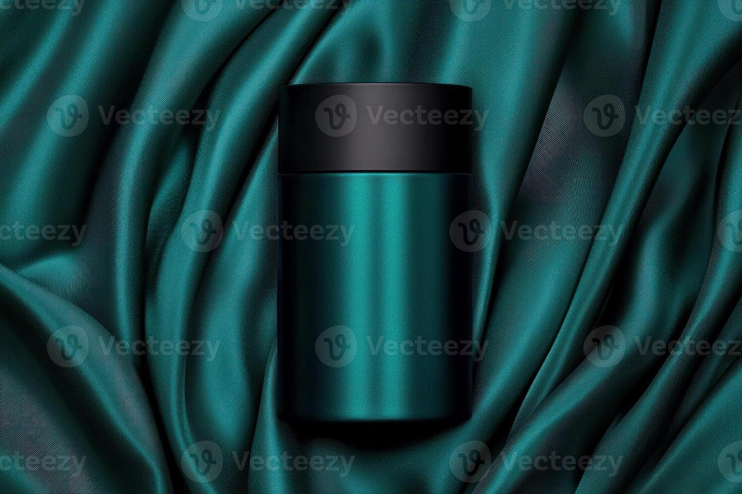 Elegant teal drink container on luxurious fabric, ideal for stylish beverage presentation. photo