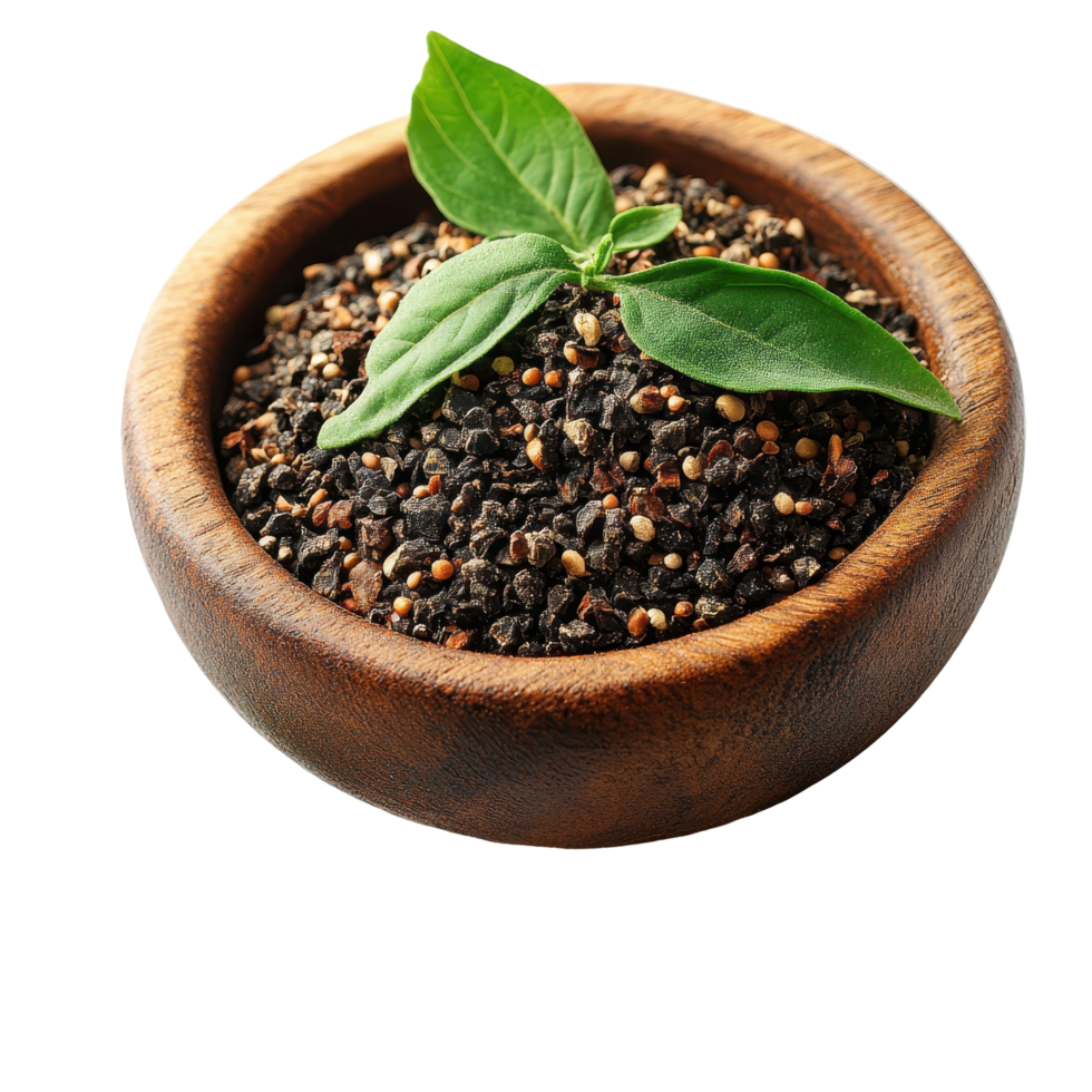 Bowl filled with black pepper seeds accompanied by a fresh basil leaf on a white background isolated on transparent background png
