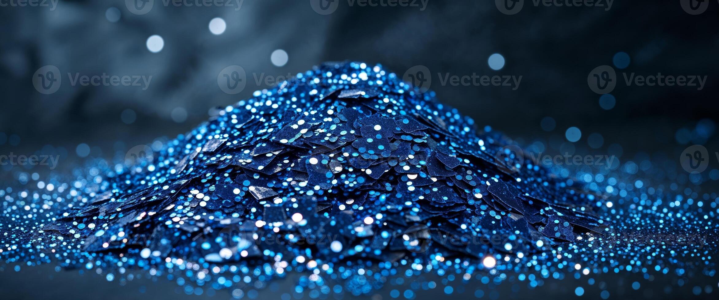Sparkling blue glitter creates a mesmerizing texture in a dark setting. photo