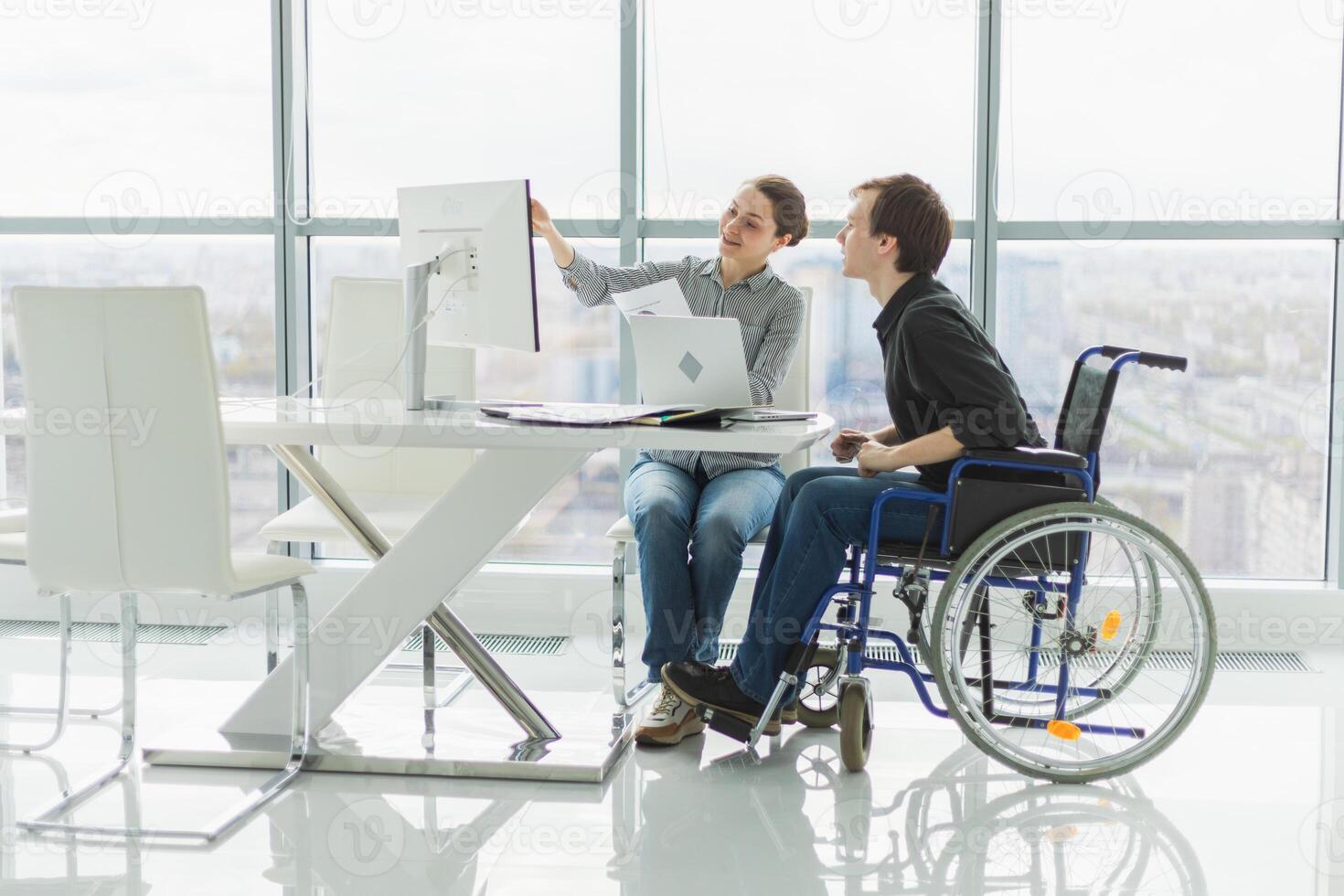 Colleagues business people woman man in chair for people with disability working on office. Startup business group team working together. Corporate professional team discussing project ideas photo