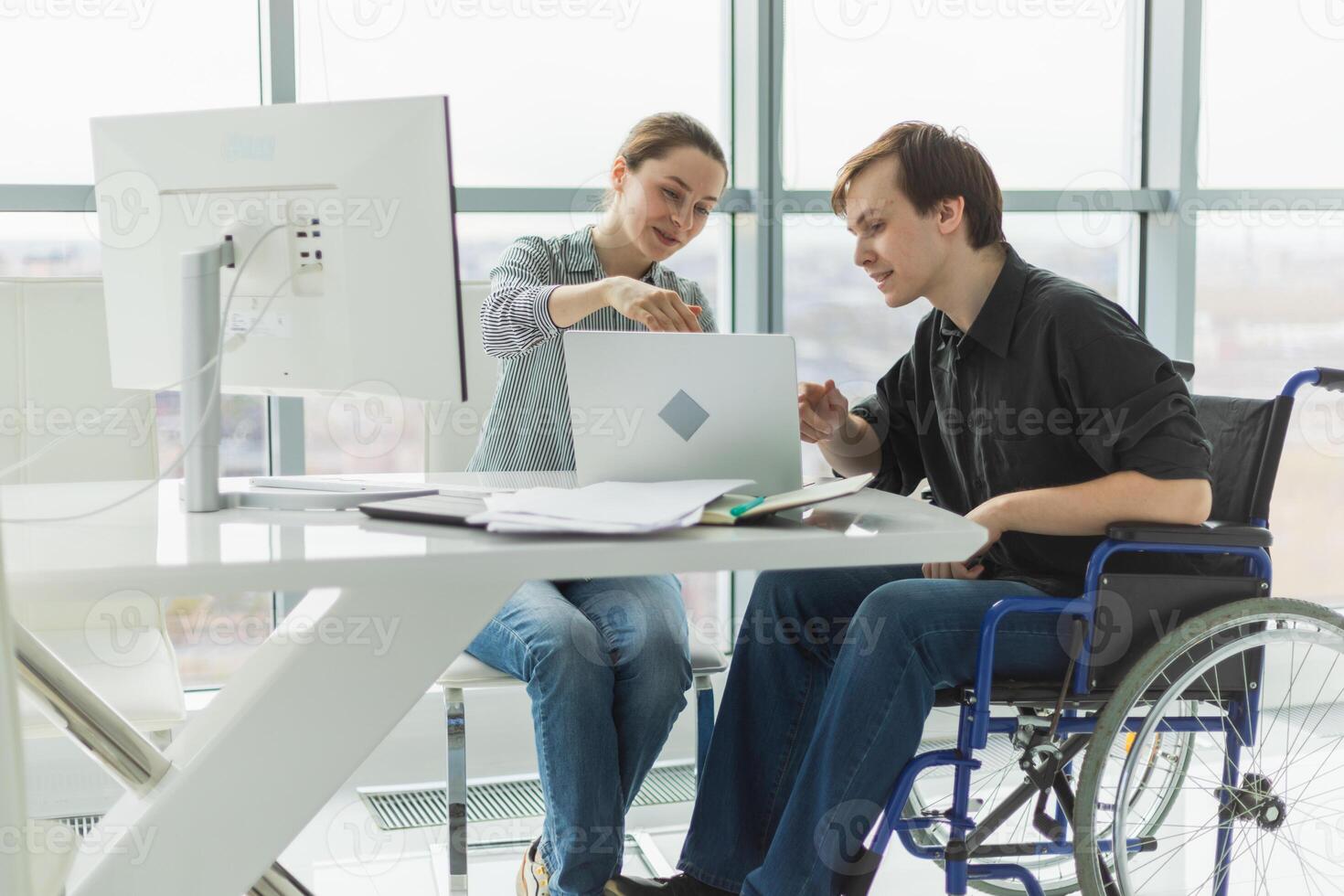 Colleagues business people woman man in chair for people with disability working on office. Startup business group team working together. Corporate professional team discussing project ideas photo