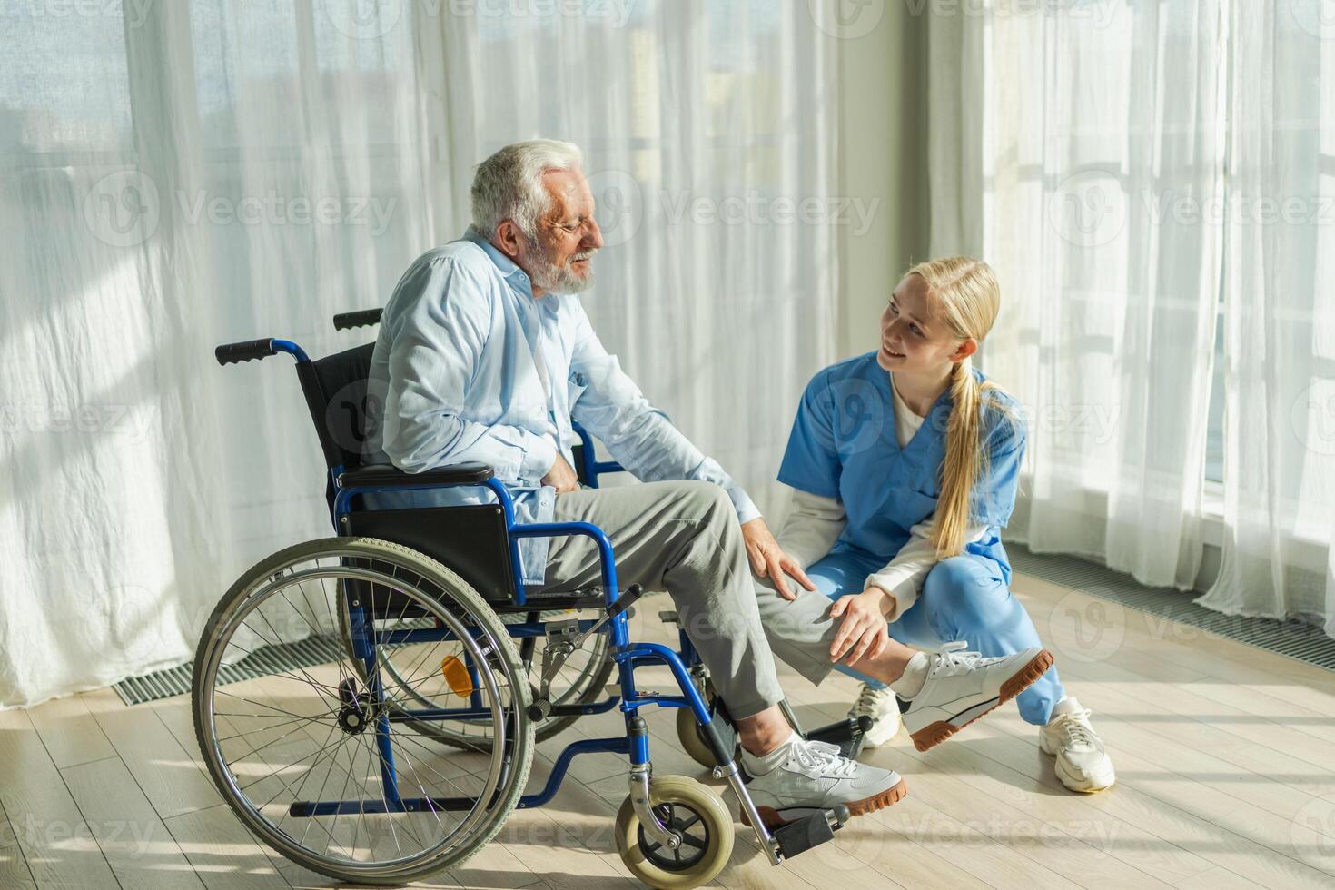 Help support retirement healthcare. Nurse helping old man in wheelchair. Patient and woman in nursing home for medical caregiver. Nurse taking care of paralyzed man in chair for people with disability photo