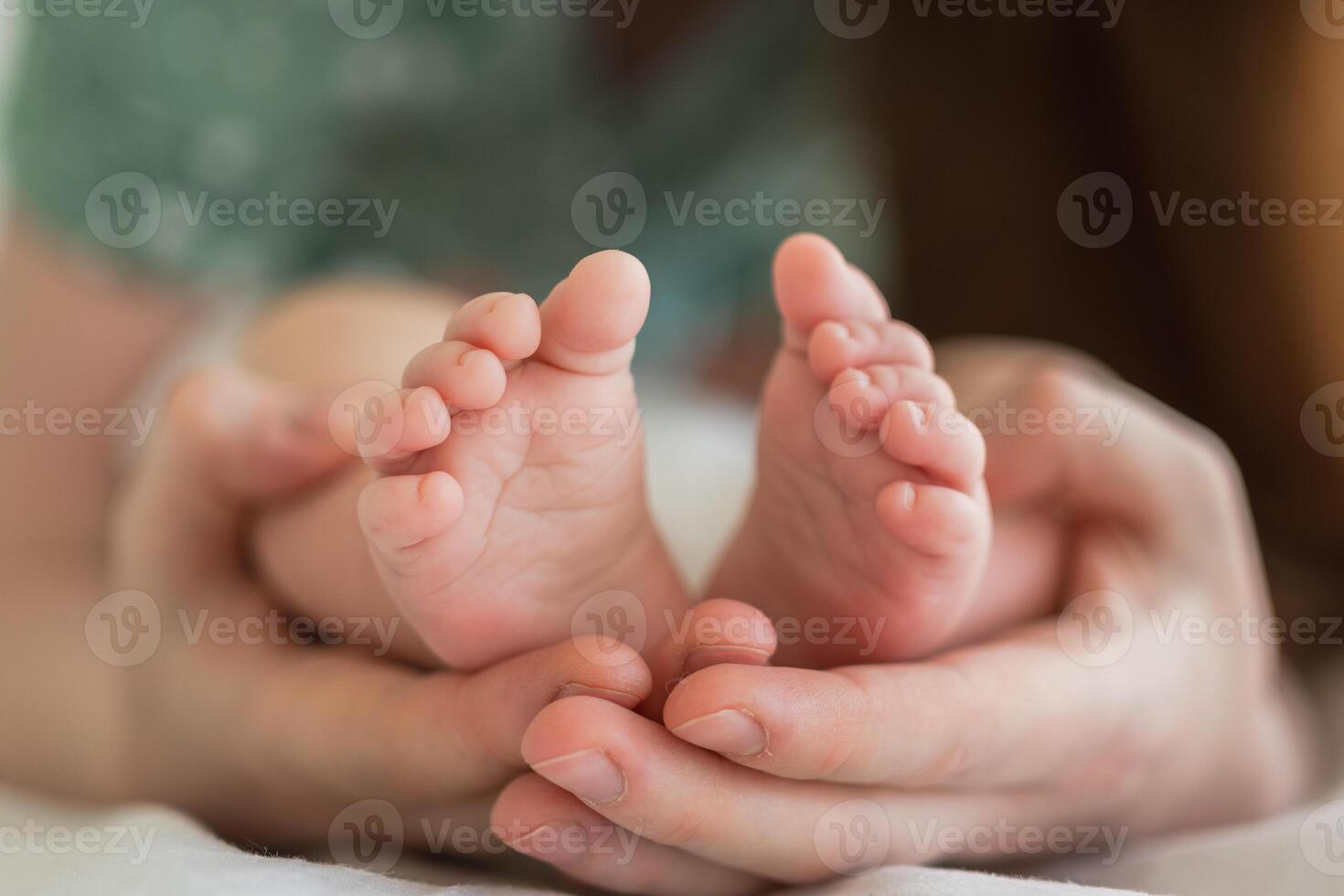 Happy family. Tiny newborn infant male or female baby feet on mother hands. Mother holding newborn child. Mom and her baby. Maternity tenderness parenthood new life concept. Handle with care photo