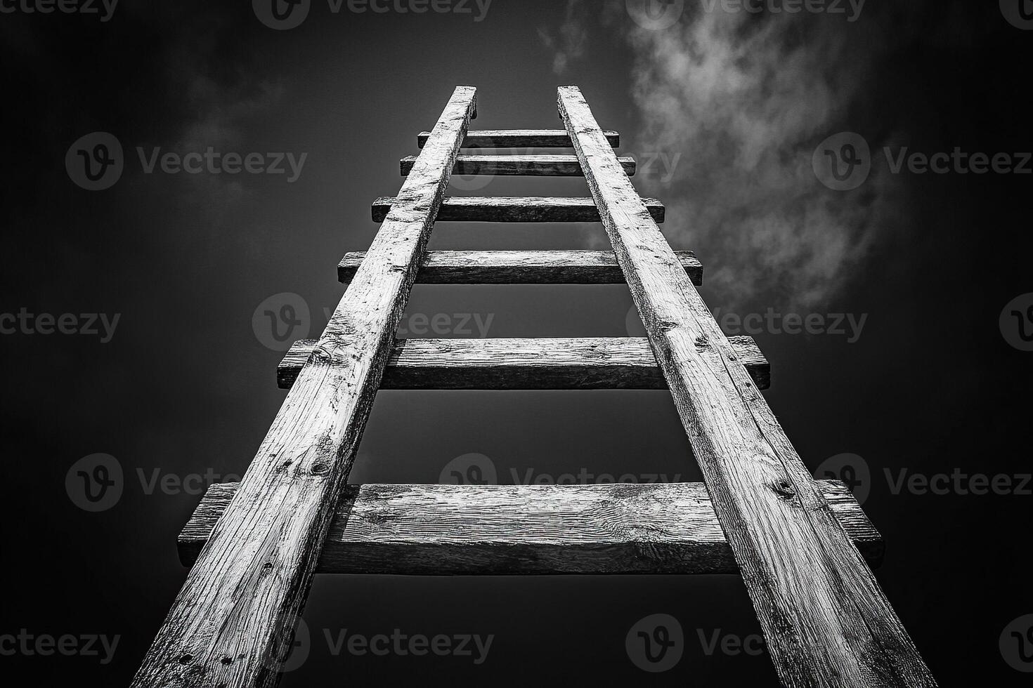 Black and white image of a wooden staircase leading high into the sky photo