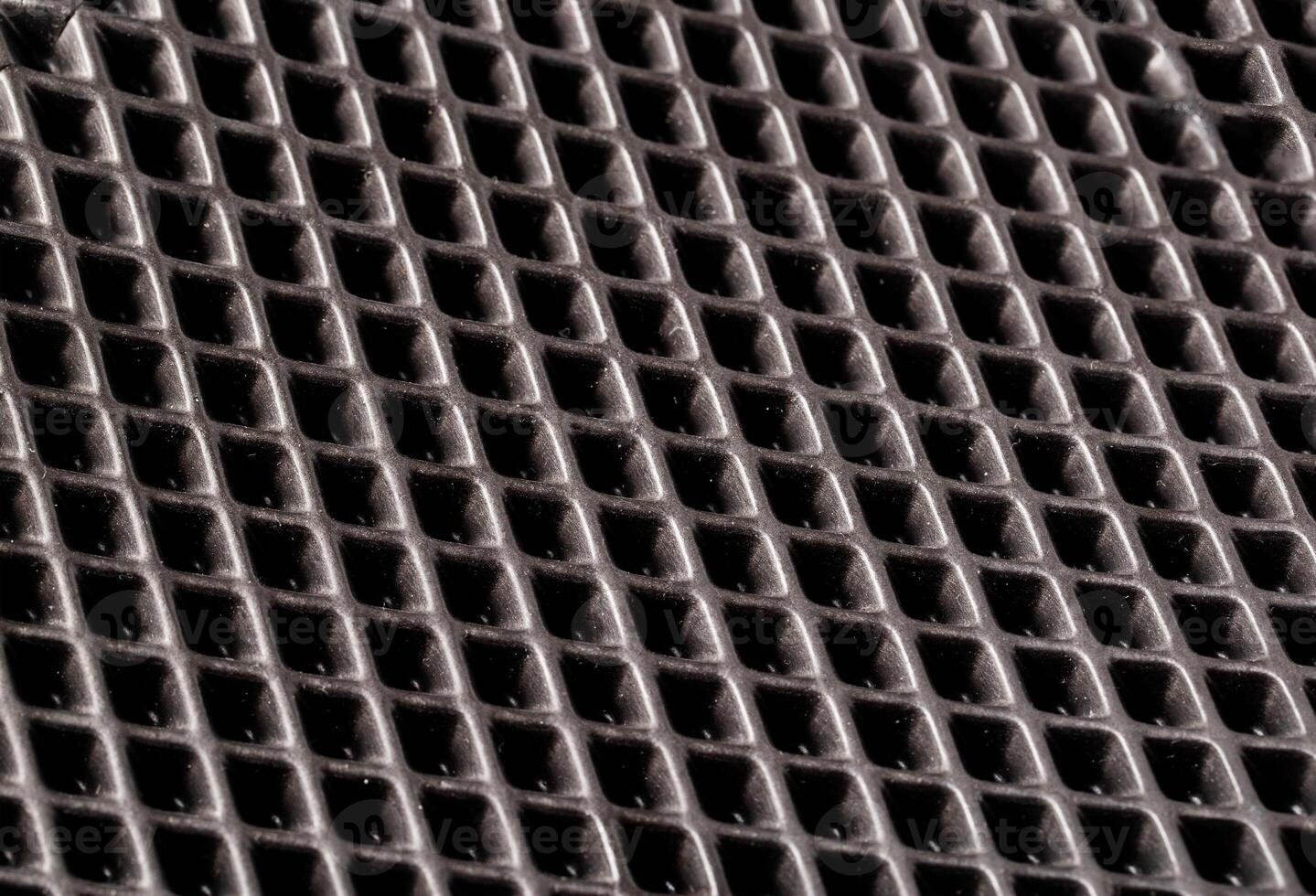 Beautiful background made of rubber mat with indentations, close-up photo