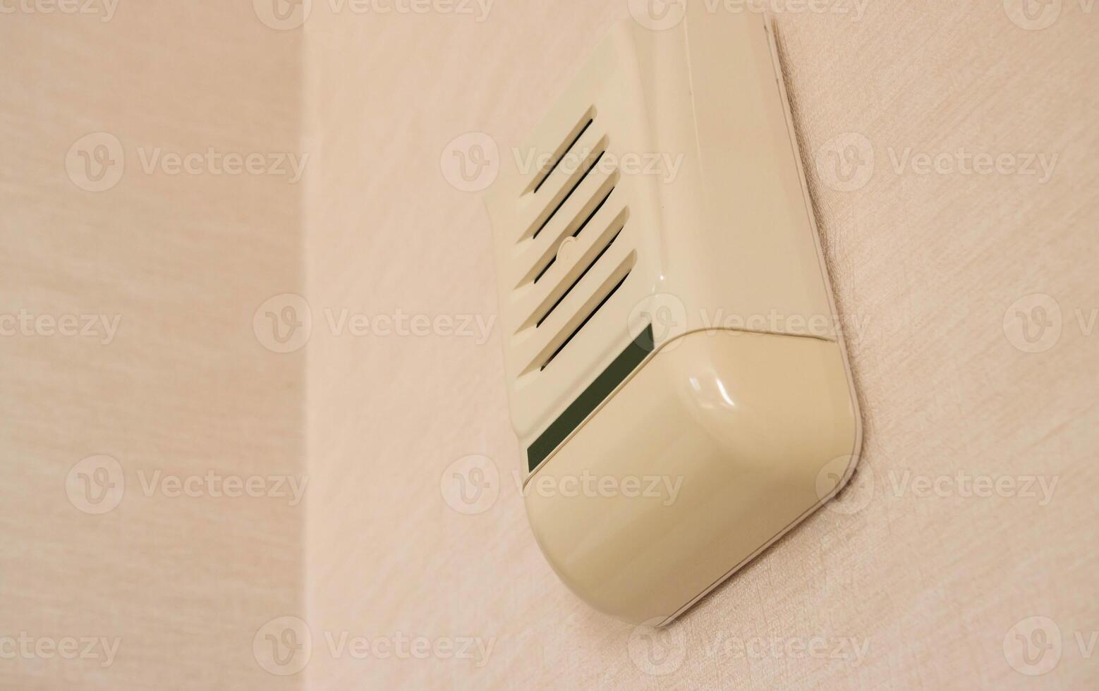 Wall-mounted device for sound notification in case of emergency and fire evacuation. Copy space for text photo